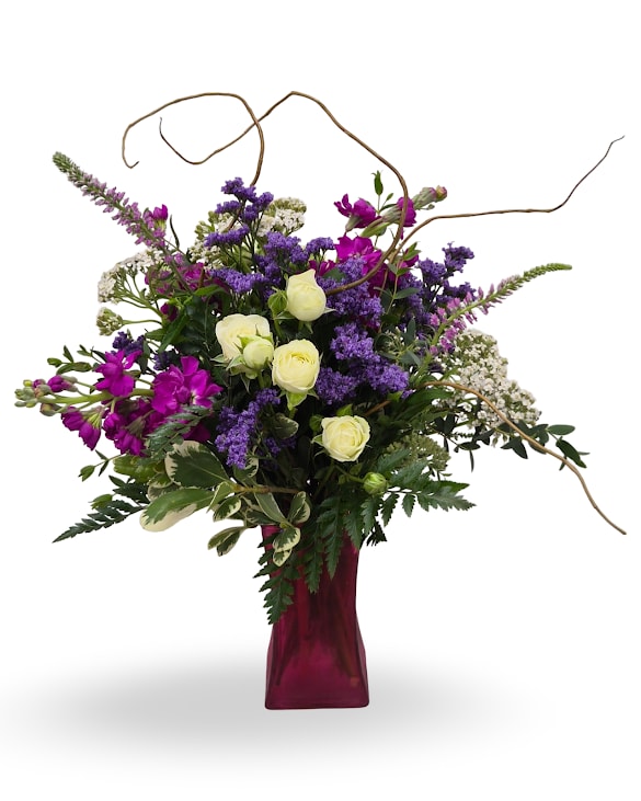 Eye Candy - Select this lovely eye-catching arrangement featuring stock, spray roses, yarrow, veronica with accents of curly willow and misty.  Approximately 18" x 7" x 12"