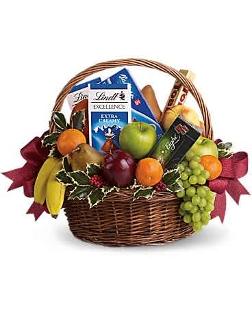 Fruit and chocolate gift basket with a wicker handle and burgundy ribbon