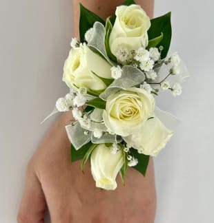 White Spray Rose Prom Corsage - White spray roses with babies breath and tulle for just the right touch of elegance. The deluxe version includes a matching boutonniere. The roses and tulle can come in a variety of colors, include color choice in the notes if ordering online.