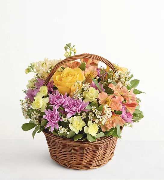 Eloise's Cottage - You don’t need your own cutting garden to give someone a basket filled with fresh blooms. Roses, Peruvian lilies, and more in sun-kissed shades of yellow, orange, and lavender are arranged in an enchanting willow basket, ready to spread cheer and delight.
