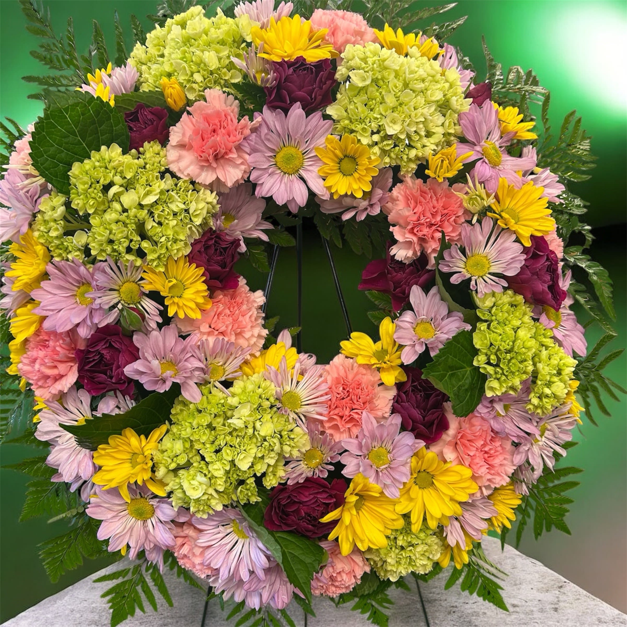 Spring sympathy wreath - Sympathy wreath featuring yellow, pink, purple and green spring blooms.
