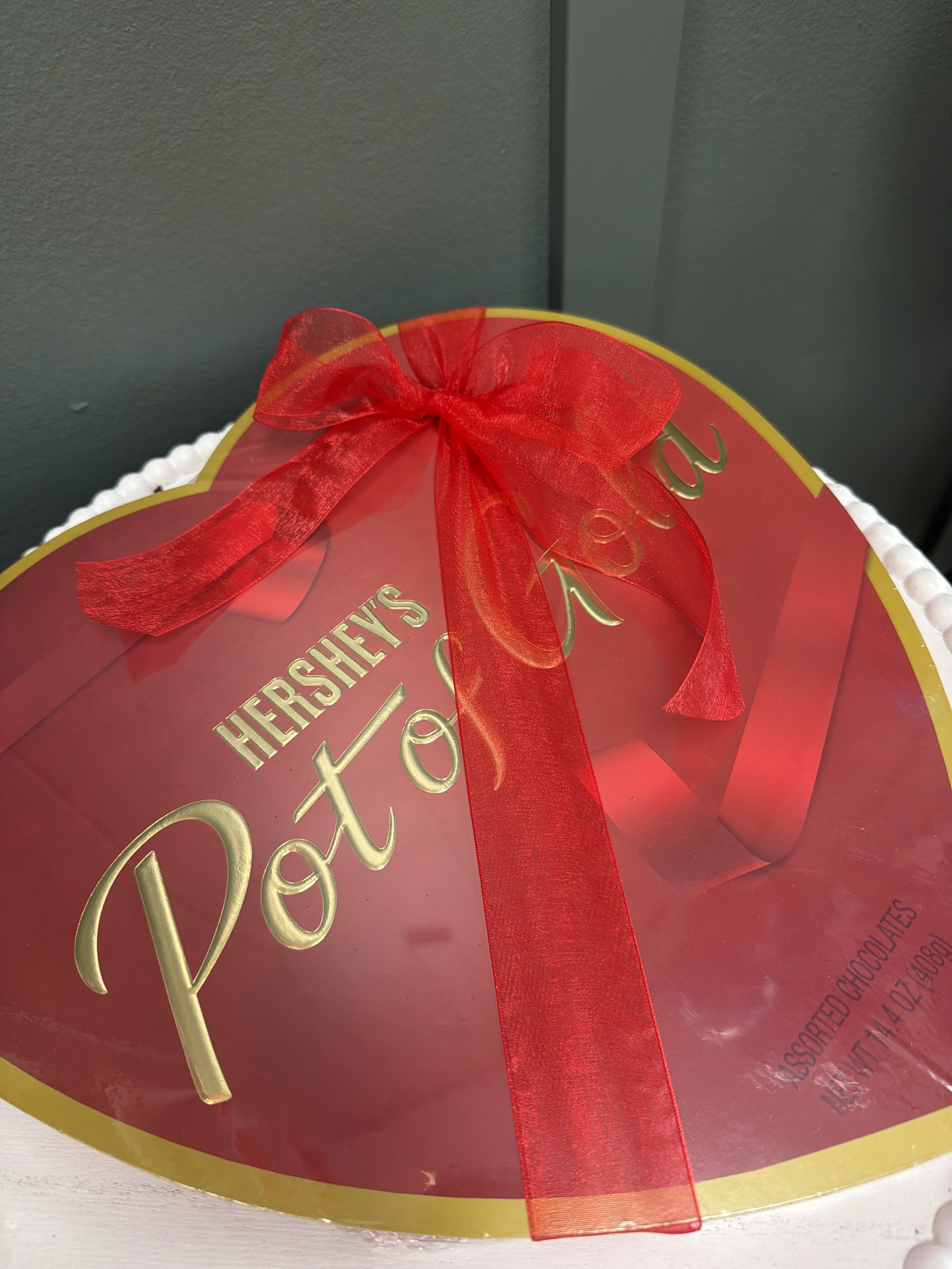 Heart-shaped Hershey's Pot of Gold chocolate box tied with a red ribbon