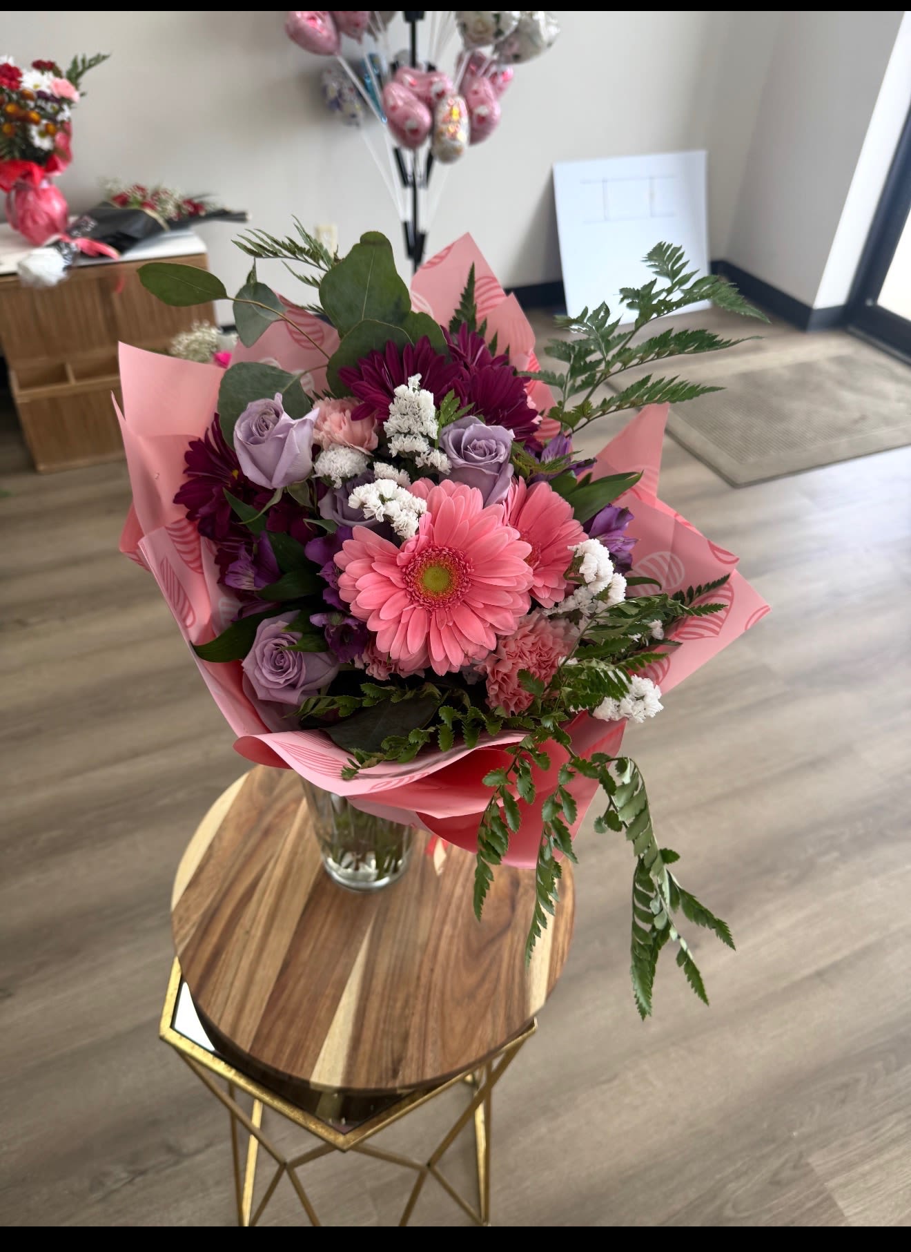 Pink and lavender bouquet in a glass vase with mixed blooms
