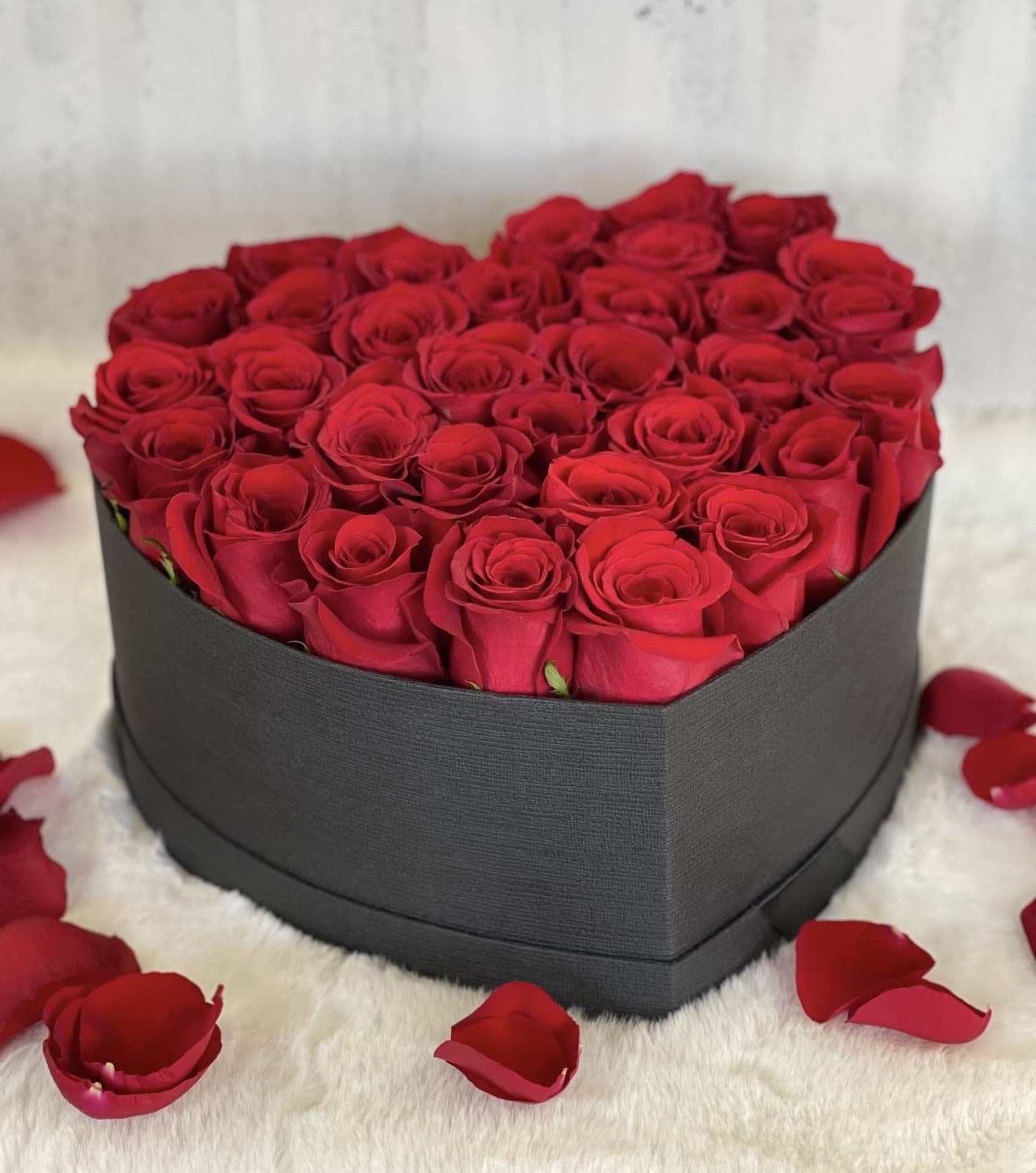 Heart-shaped box filled with red roses