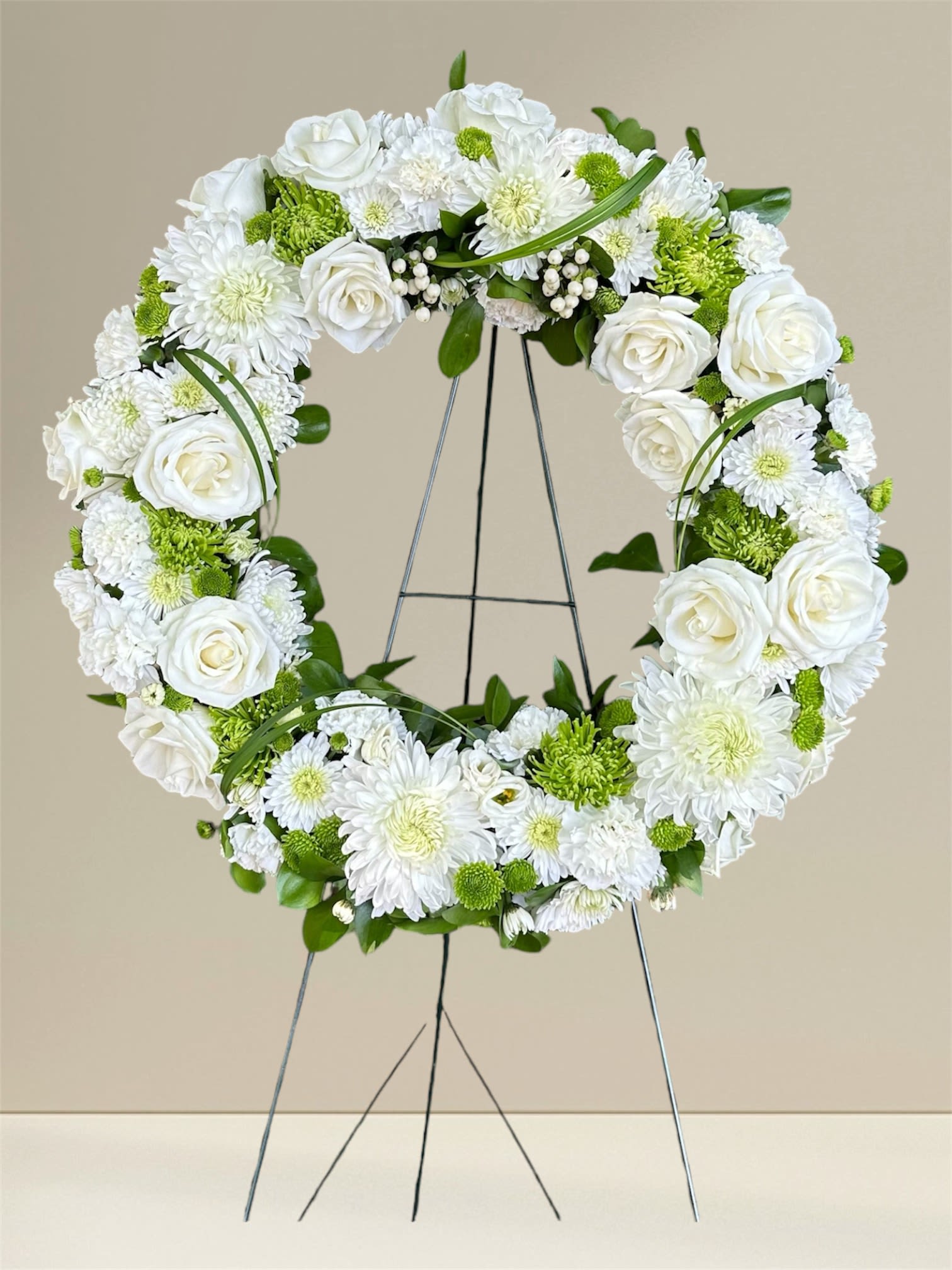Pure Serenity Wreath - "Pure Serenity: A Tribute in White" is an elegant wreath that symbolizes peace and remembrance. Crafted with pristine white roses and delicate chrysanthemums, it's perfect for honoring loved ones and creating a serene, reflective atmosphere. Let this beautiful arrangement speak of love, respect, and lasting memories.