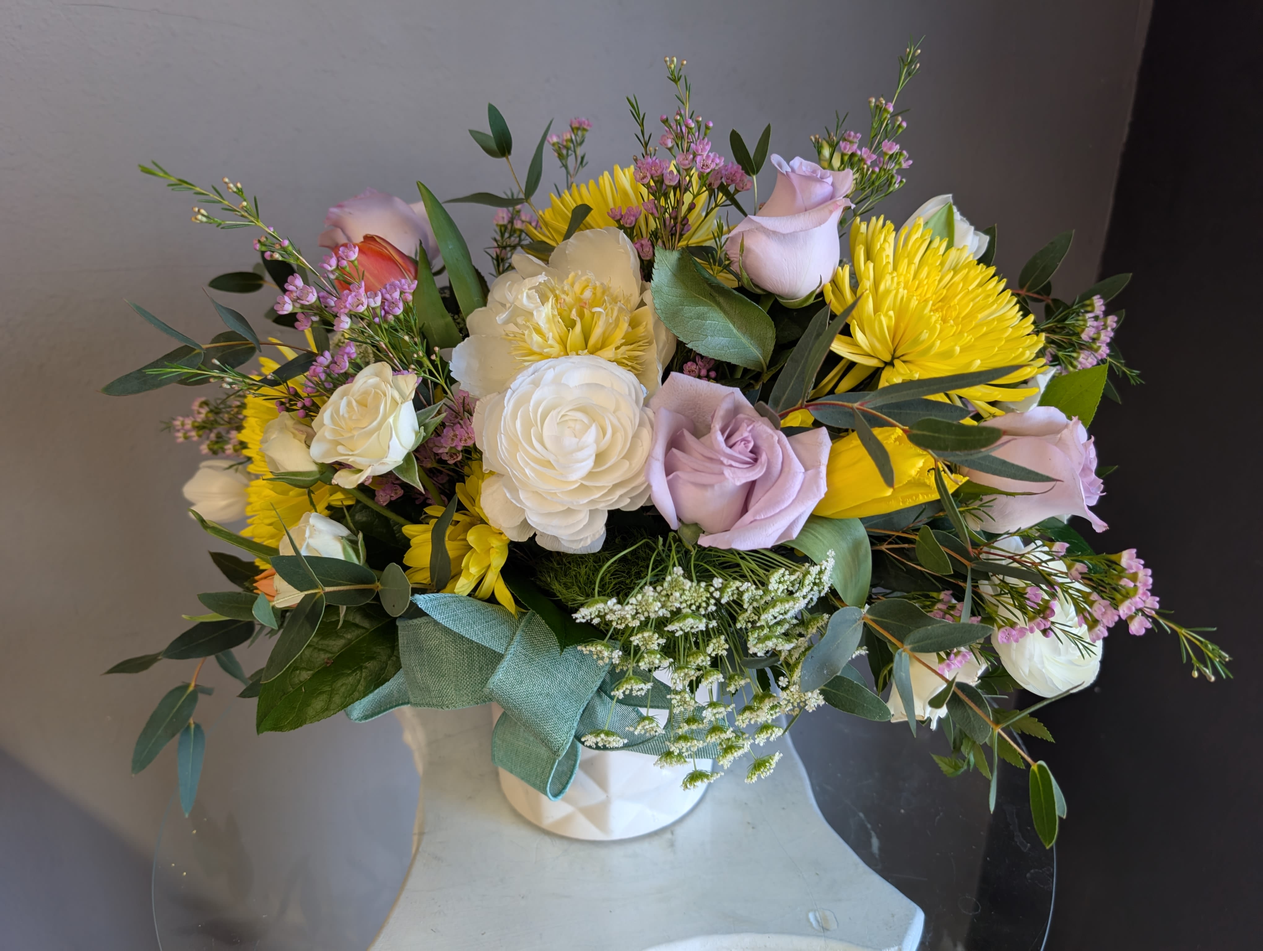 #719 Designer's Choice Seasonal Flower Arrangement - This beautiful flower arrangement of fresh mixed seasonal blooms is made by local designers in the heart Orange California. Hand crafted and perfect for every occasion, from birthdays and new babies to sympathy and just because. The best choice to show you are thinking of that special someone. Can be sent as a local delivery or in-store pickup. This is an original, one of a kind arrangement. Order now before it's too late!  UPGRADES: All upgrades are applied at the designer’s discretion and fulfilled to value using the freshest seasonal and/or premium flowers available. Container upgrades may be included when possible; otherwise, value is reflected in the floral selection while maintaining the original design style.