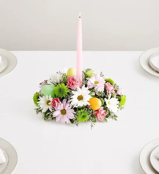 Easter Centerpiece - Easter celebrations call for beautiful flowers. Our classic centerpiece is filled with pastel blooms and accented by colorful plastic Easter eggs for a playful touch. Elegant taper candles finish off this charming arrangement, which is sure to be the bright spot of the holiday table.