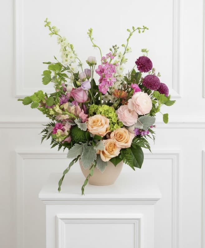 Grand Expression  - A lush and elegant floral display, filled with color and warmth in honor of a beautiful life.  Designed in a neutral ceramic vessel to be enjoyed with at the service or in the residence.  Pictured is standard size. 