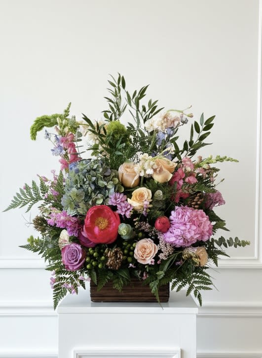 Vibrance Traditions Basket  - Celebrate the memory of a vibrant and joyful lost loved one with this beautiful sympathy basket. Our designers will incorporate colors such as purple, pinks, corals and lime greens in some of our favorite seasonal blossoms.   Please note, this piece is intended for the funeral service, and not for a residence.  Approx 32" tall and wide. 