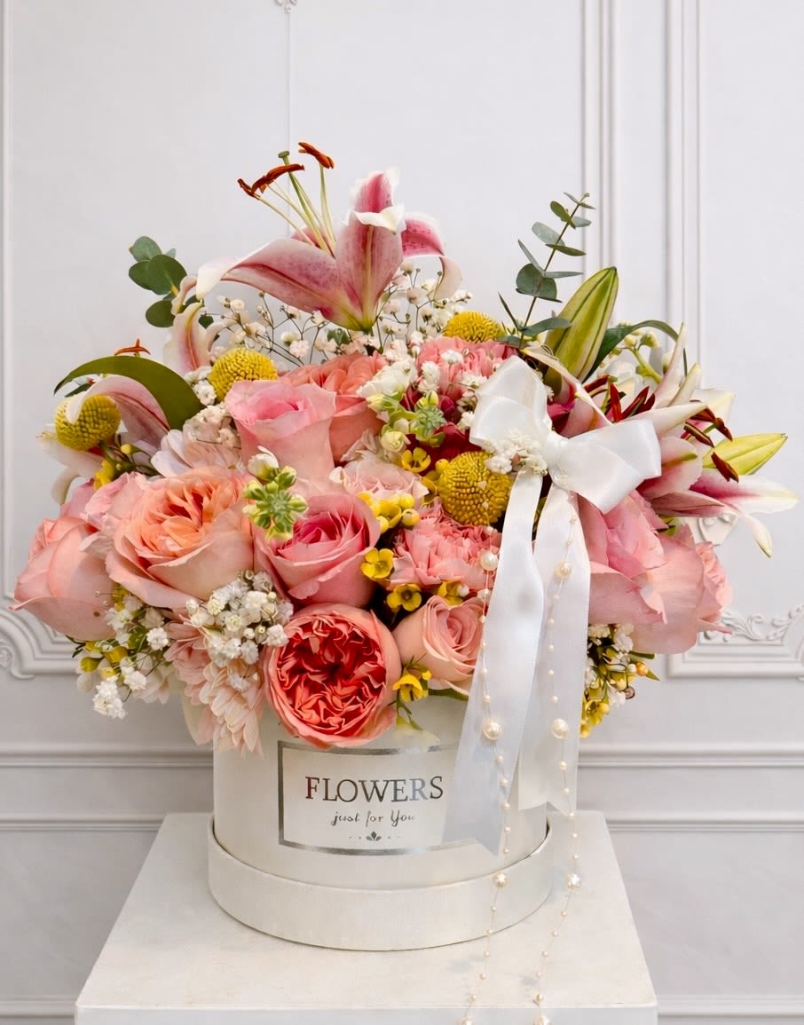 Eternal Rose - A timeless expression of elegance and love, designed in our signature nature European inspired, luxury floral style. Featuring soft oink garden roses, premium lilies, delicate baby's breath ,golden billy balls, and fresh eucalyptus, this arrangement is thoughtfully styled in a keepsake white hat box finished with a graceful satin ribbon and pearl accents.  perfect for Valentine’s Day, birthdays,  anniversaries, sympathy, or "just because". handcrafted with fresh, premium blooms by Oh Flower by Naz, your trusted local florist in Carlsbad serving North County San Diego, including Encinitas, Vista, Oceanside, Rancho Santa Fe, and San Marcos.
