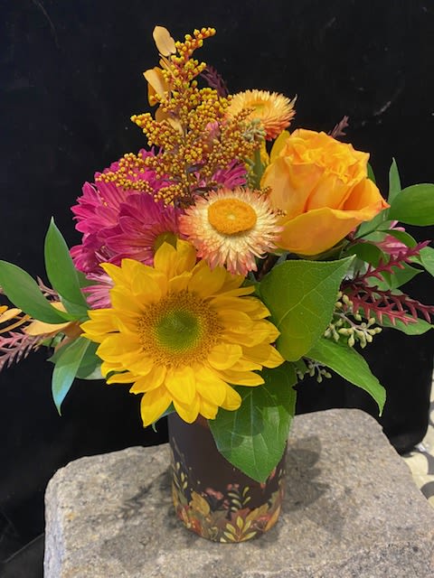 Vermont Sugar Maples - Fall is a wonderful season full of fun activities.  First comes apple picking in September around these parts.  But maple sugaring up north in Vermont is another Fall activity. Our newest team member attended school in Vermont and is the inspiration for this arrangement.  We love the warm colors of the blooms and the vase is neat too with handpainted Fall decorations all around the base. Ellie, this one is for you!