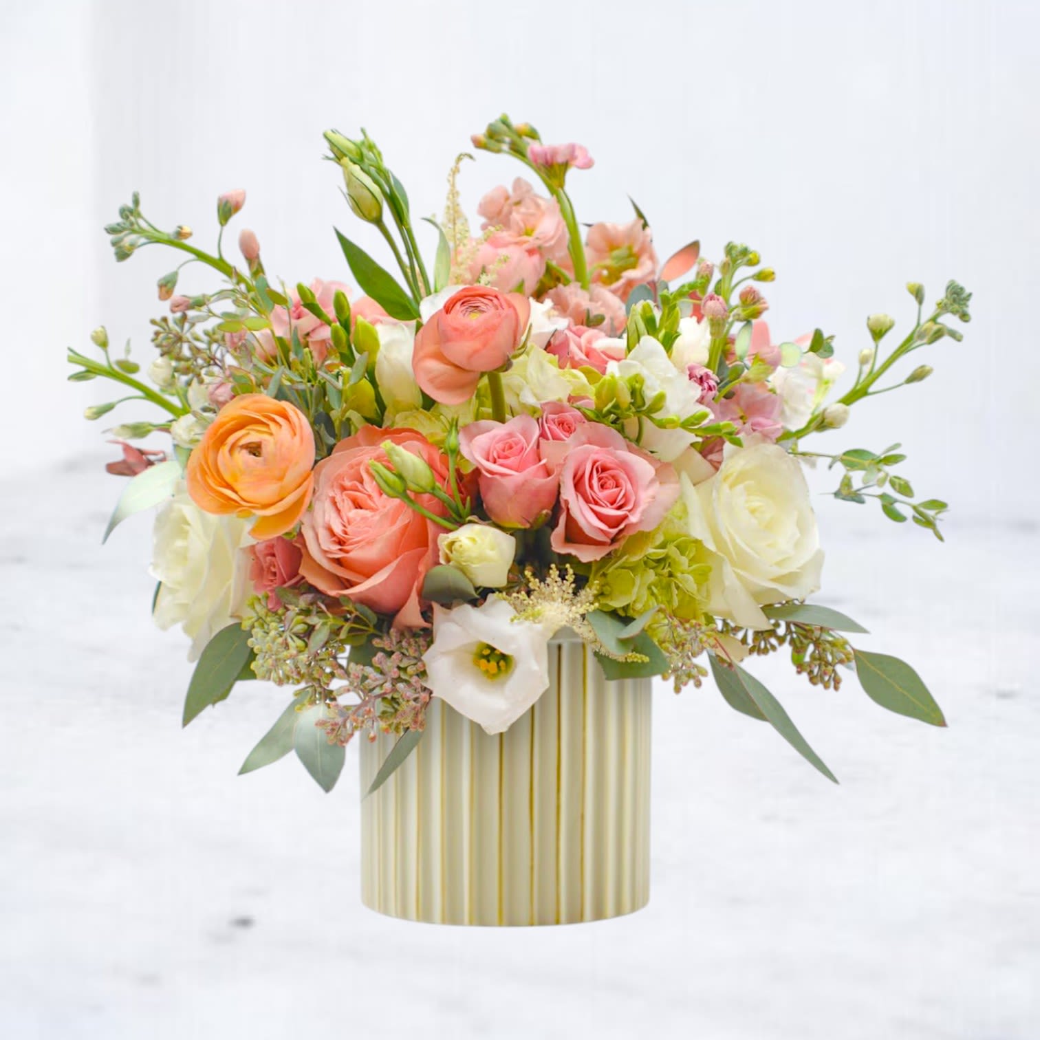 Peach &amp; Cream - Peach Standard is a soft, elevated flower arrangement designed with peach roses, blush blooms, hydrangea, and fresh seasonal accents. Arranged with lush greenery in a modern ceramic vase, this design blends warm tones and soft texture for a full, balanced look. Peach and blush flower arrangements are a popular choice for birthdays, Mother’s Day, anniversaries, and everyday flower delivery. The warm color palette creates a welcoming, feminine feel that works beautifully in homes, offices, and special occasions.  Each arrangement is hand-designed using fresh, high-quality flowers. Flower varieties may vary based on seasonal availability, but the overall color palette, shape, and style will be carefully maintained.  Peach Standard is available for same-day flower delivery in Magnolia, Montgomery, The Woodlands, Conroe, and surrounding North Houston areas. Ordering from a local florist ensures your flowers are designed fresh and delivered quickly for any last-minute or meaningful moment.  This arrangement is a reliable choice when you want something soft, full, and beautifully put together.
