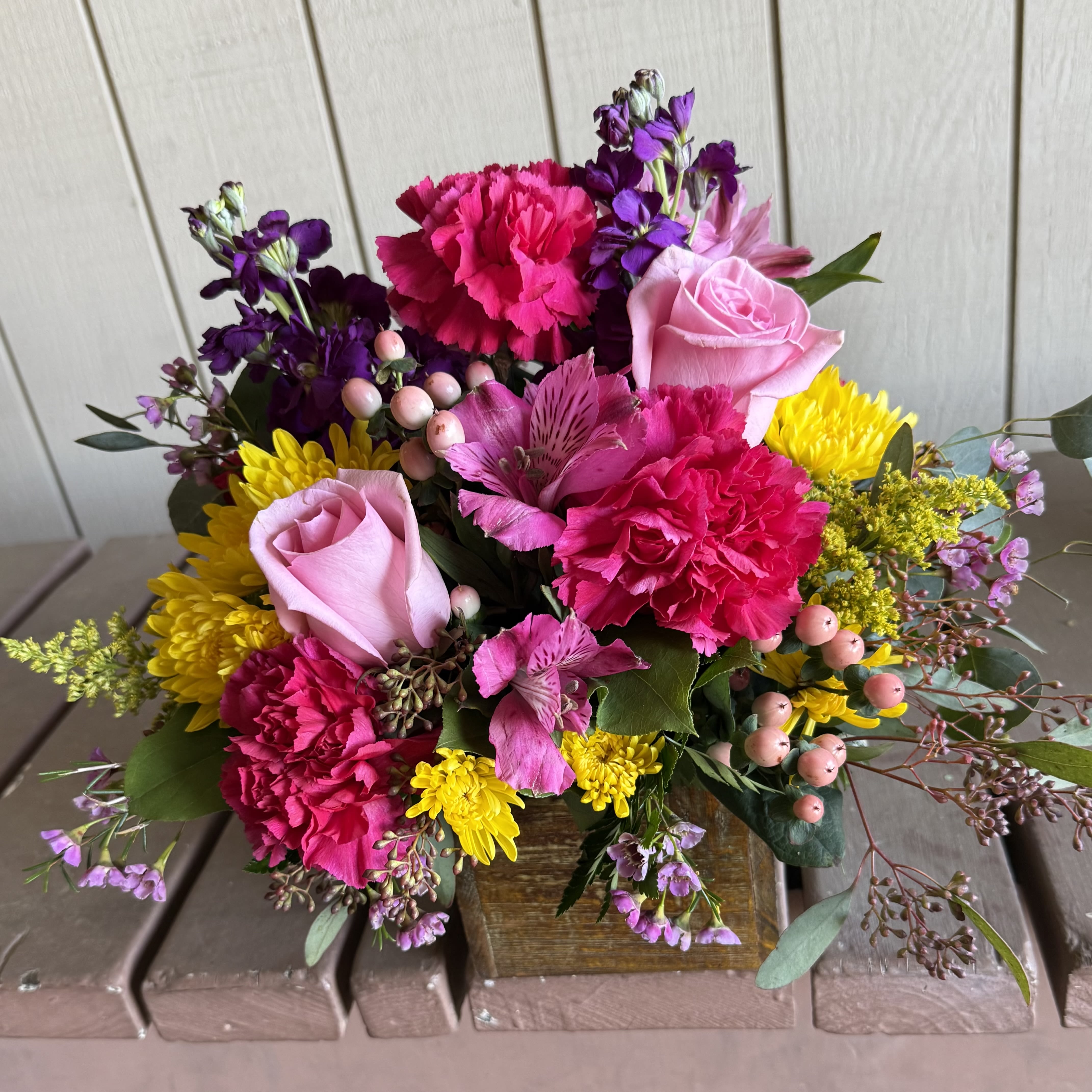 Bright Spring Box - Brighten up someones day with this beautiful wooden box filled with brilliant colored flowers.