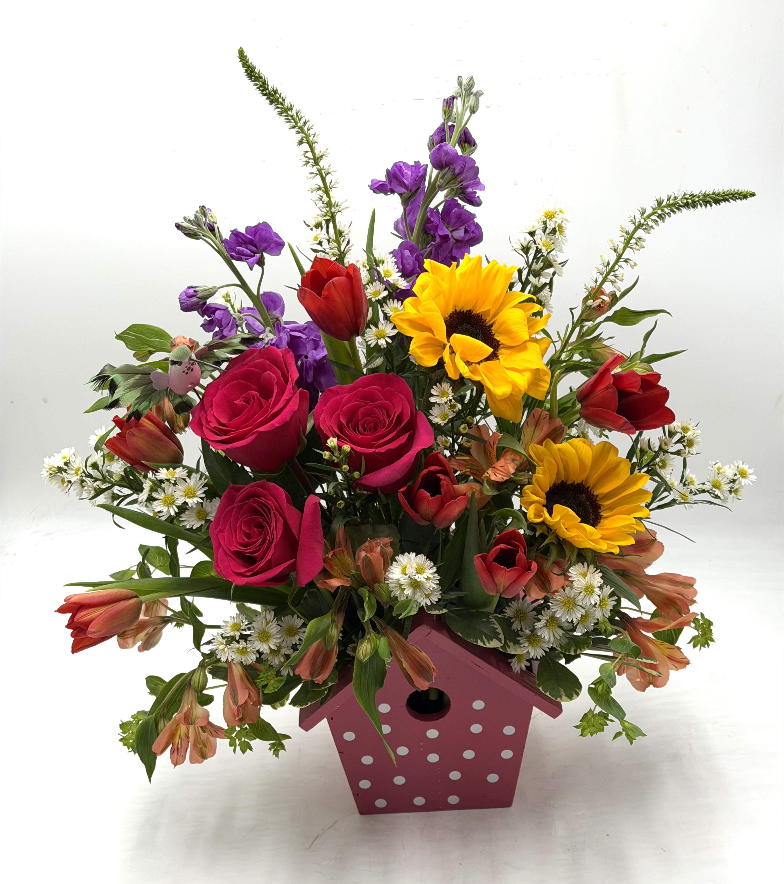 Sunny Garden Songbird - A cheerful, garden - inspired arrangement bursting with color and charm artfully designed in a polka-dot birdhouse container. Perfect for brightening someone's day or celebrating life's sweetest moments! ** CONTAINER COLOR WILL VARY!! **