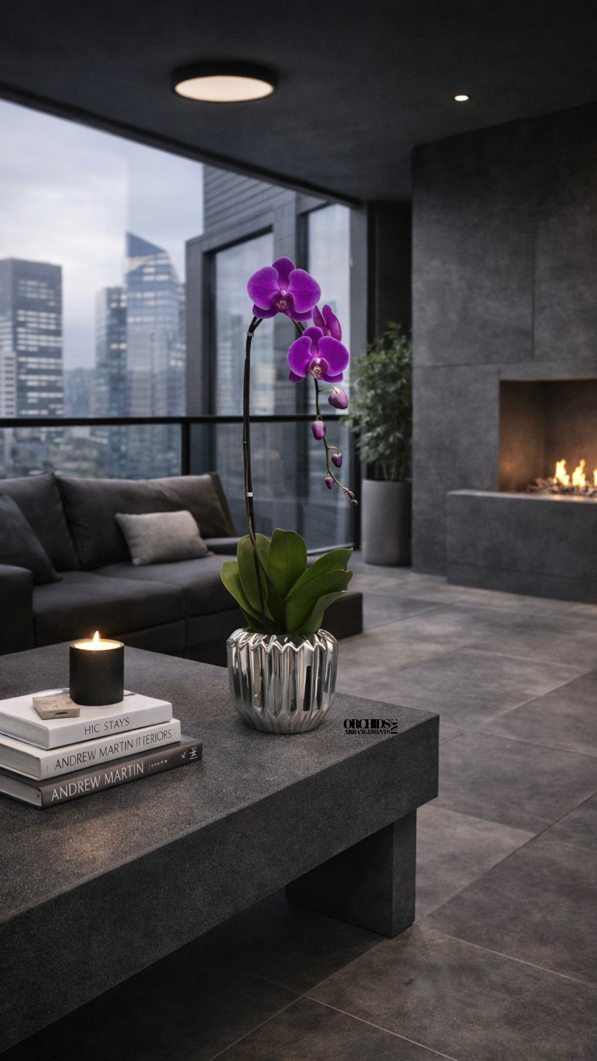 Purple Phalaenopsis Orchid – Designer Collection - This elegant Single Purple Phalaenopsis Cascade orchid arrangement creates a striking vertical presence, making it ideal for grand interiors and modern living spaces with a vase 7" D X 7" T. 