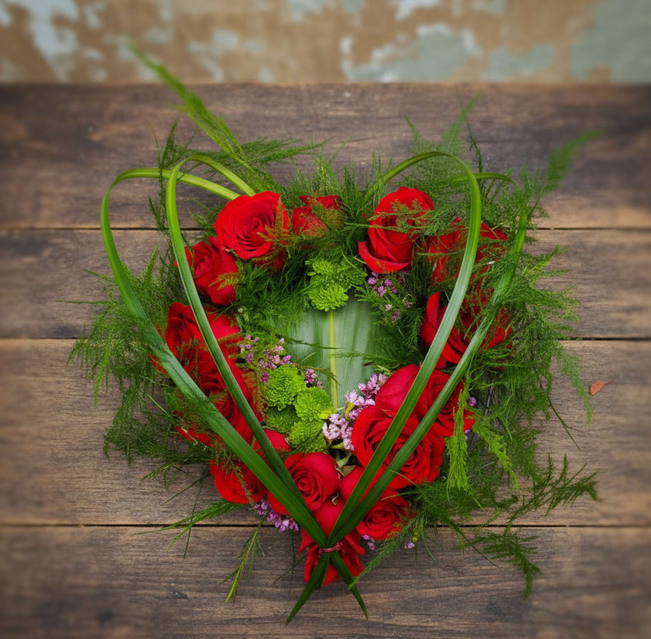 Forever Yours - Forever Yours – Anniversary Flowers Tumwater, WA | Same-Day Flower Delivery  Looking for anniversary flowers in Tumwater, WA? Forever Yours is a romantic and unforgettable arrangement from Specialty Floral Design, your trusted local florist near Tumwater. Designed to make a lasting impression, this bouquet is perfect for anniversaries, Valentine’s Day, or any moment you want to say “I love you.”  This unique design features premium red roses arranged in a heart shape, accented with fresh greenery and soft purple blooms for added depth and elegance. It’s a beautiful twist on classic rose bouquets, making it one of the most eye-catching romantic flower arrangements in Tumwater, WA.  We proudly offer same-day flower delivery in Tumwater, Olympia, Lacey, and surrounding areas. As a local florist, we handcraft every arrangement with care using the freshest flowers available.  Order anniversary flowers in Tumwater, WA today and surprise someone special with a meaningful, handcrafted bouquet.  Care Tip: Change water daily to keep your roses fresh and vibrant.