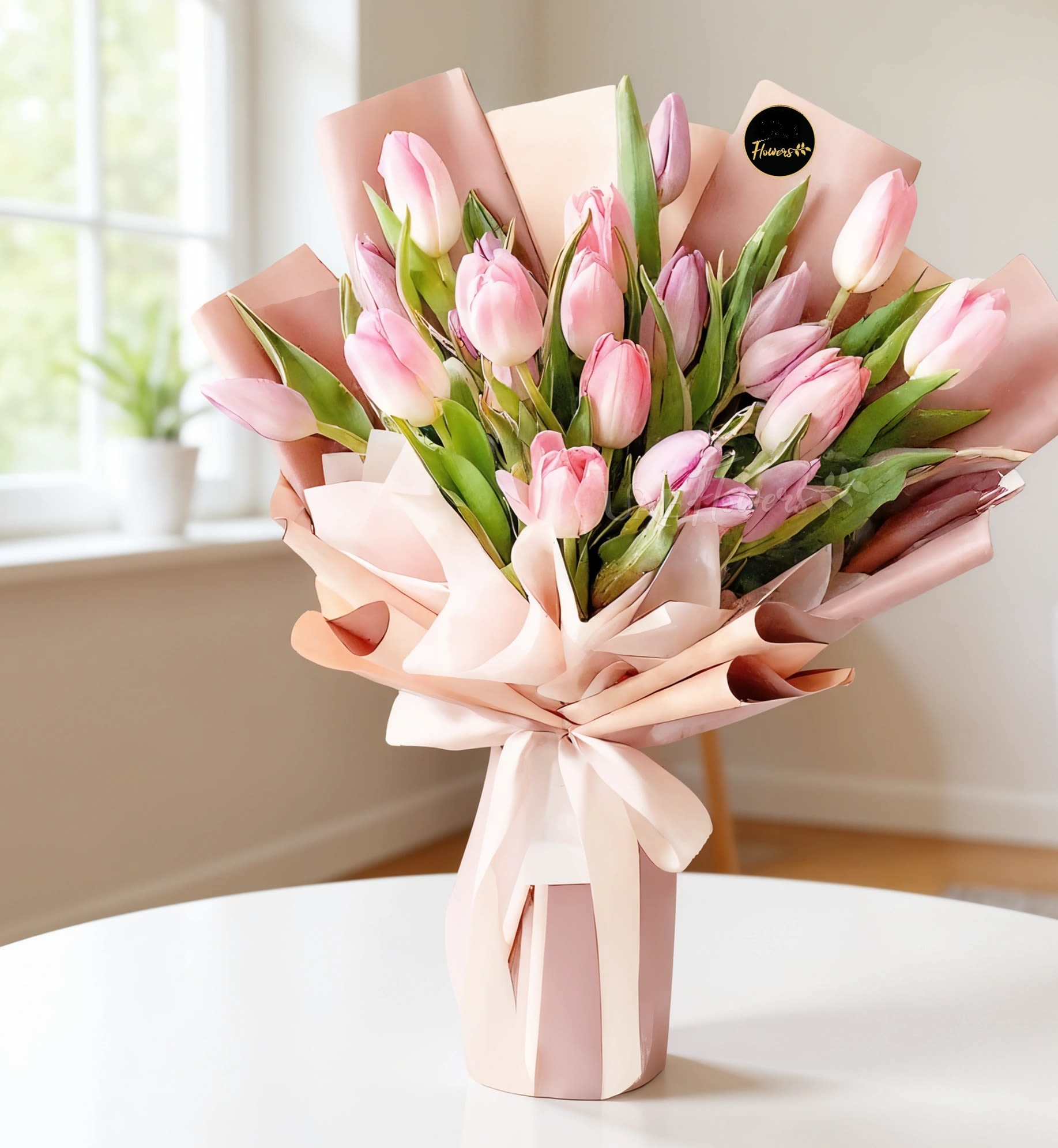 Wrapped bouquet of pink and lavender tulips in blush paper with a large bow
