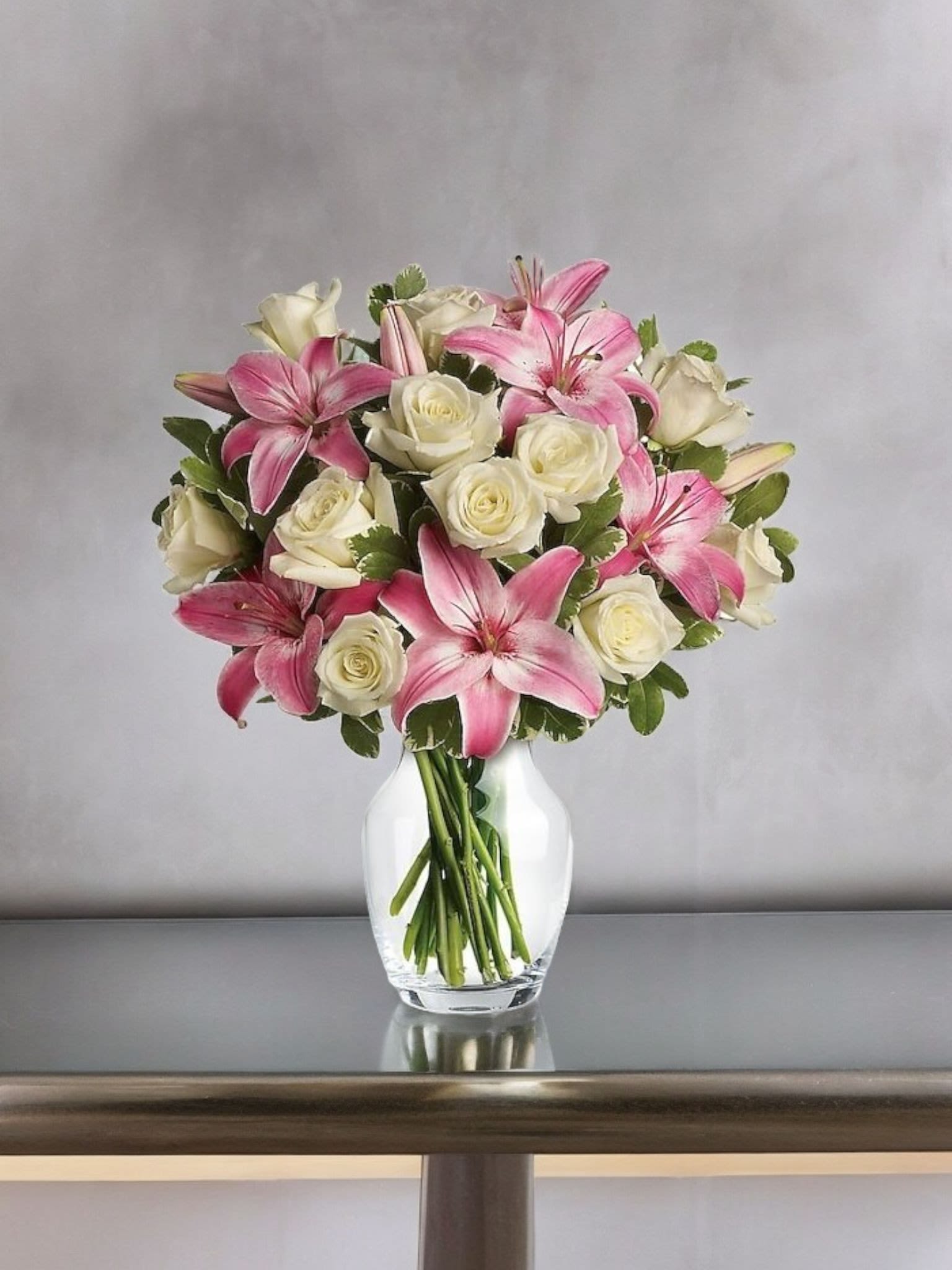 Always a Lady - White roses with pink lilies in a clear vase 