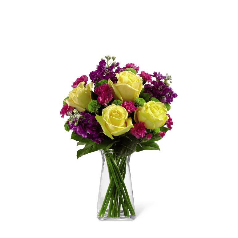HAPPY TIMES BOUQUET - The Happy Times Bouquet employs roses and stock to bring vibrant  color and fragrance straight to their door on their special day. Yellow  roses, purple stock, green button poms, fuchsia mini carnations and lush  greens create a stunning display beautifully arranged in a clear  gathered square glass vase to help you convey your happy birthday wishes  or send your congratulations. GOOD bouquet includes 13 stems. Approx.  14H x 12W. BETTER bouquet includes 17 stems. Approx. 15H x 13W. BEST  bouquet includes 21 stems. Approx. 20H x 16W. 