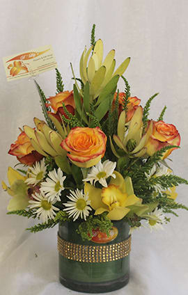 Yellow Paradise by D'Lily's Flowers  - This is an arrangement perfect for any occasion. The main colors are yellow, orange and white.   The standard size is a small to medium flower arrangement. 