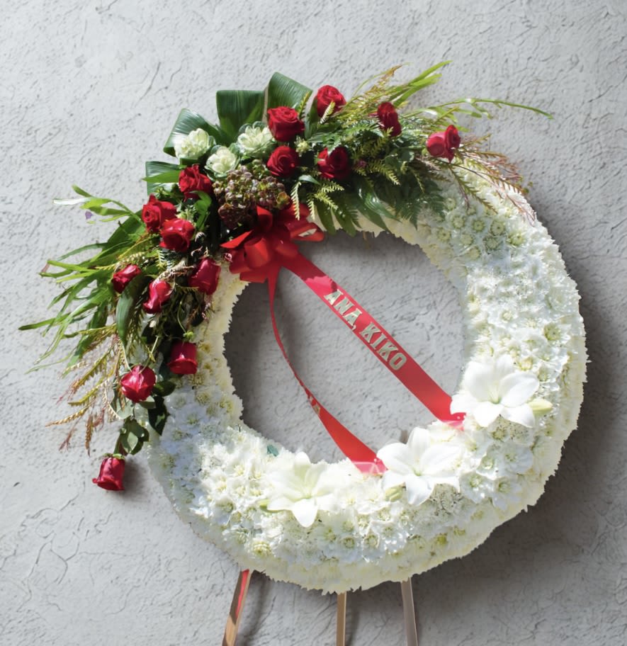 Ray of Hope - An all white wreath white a pop of reds and greenery for your loved one. Disclaimer: Flowers may be substituted if needed    DOES NOT INCLUDE RIBBON.