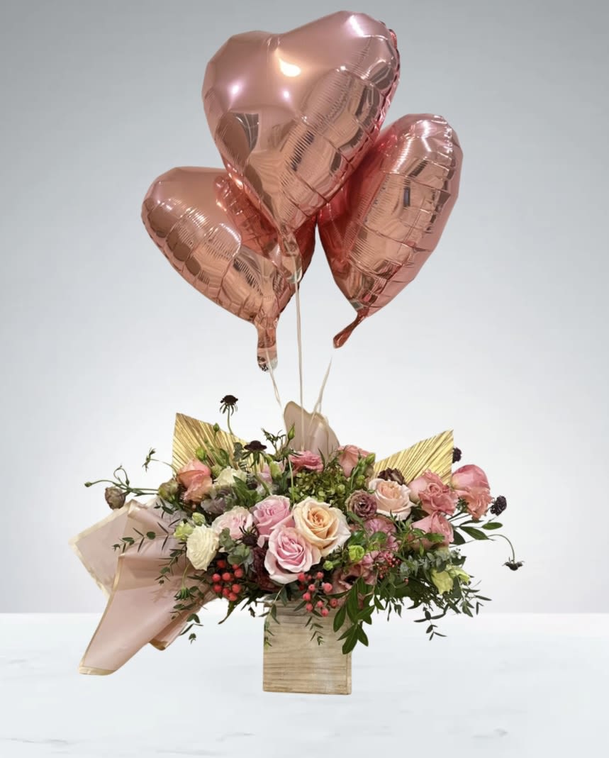  Precious Delight  by D'Lily's Flowers  - This stunning bouquet holds a ravishing mix of pinks and peach flowers, which include roses, lisianthus an a couple green hydrendias. With it, includes 3 beautiful heart shaped balloons to add that extra love!  Disclaimer:Flowers may be substituted if needed too. 