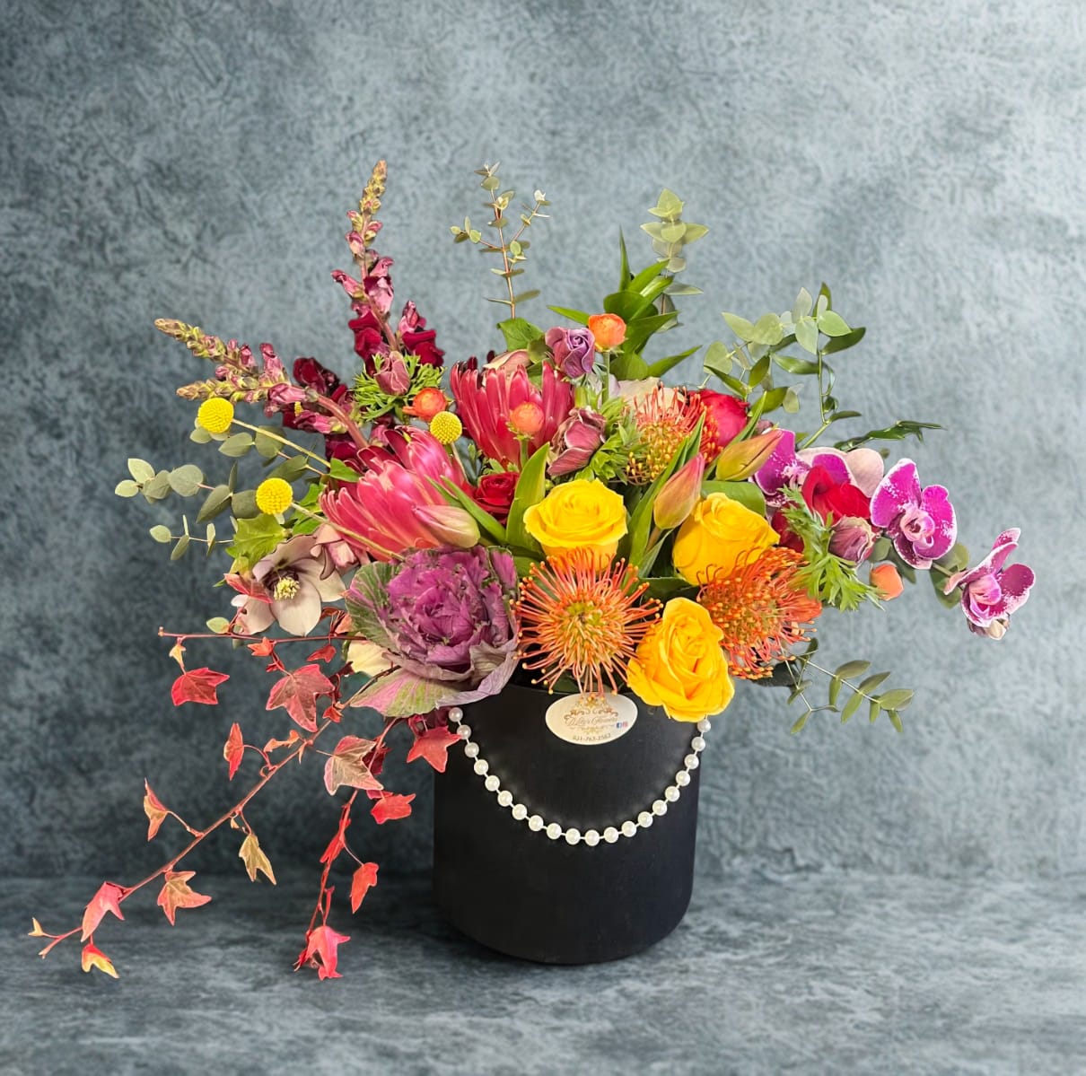 Tropical Paradise by D'Lily's Flowers  -  These tropical blooms will give them a sense of paradise right at home.  Disclaimer: Flowers may be substituted if needed to. 