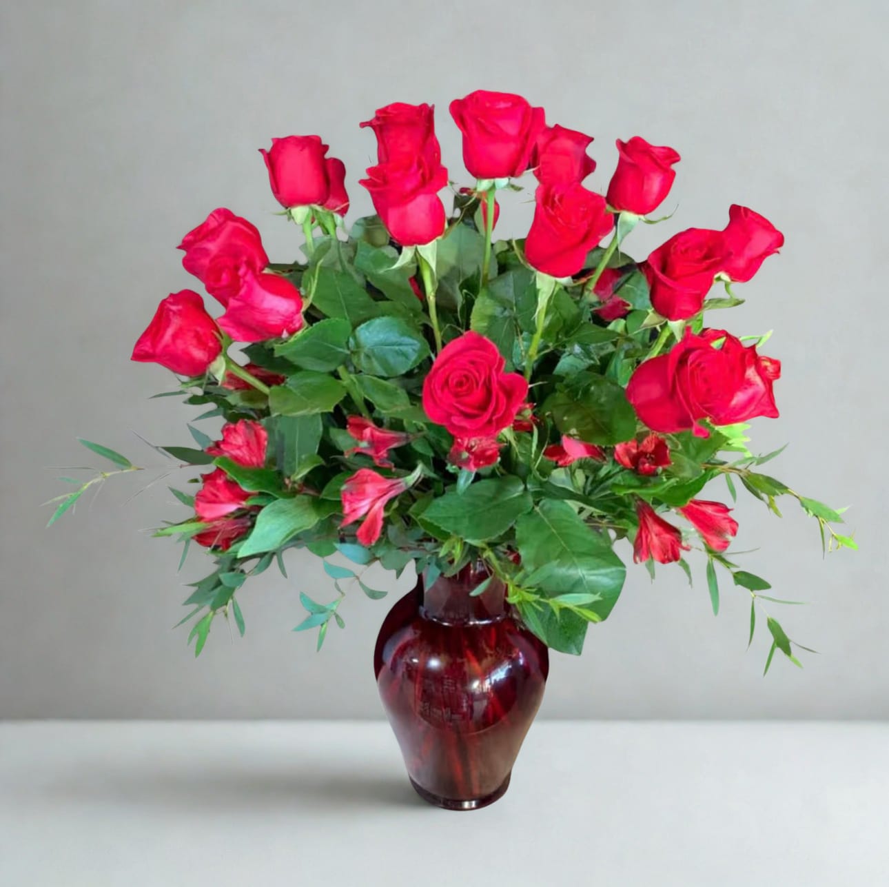 Red Love  by D'Lily's Flowers  -  A beautiful arrangement of lovely red roses, accented with fresh greenery in a clear glass vase. Simple, elegant, and perfect for any occasion.