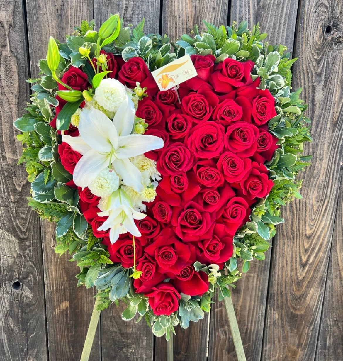 Majestic Heart  - Elegant red roses and with greenery on the outside and white lilys.                                                                     DOES NOT INCLUDE RIBBON