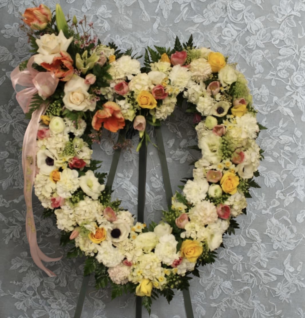 Loving Care - A beautiful mixture of pastel colored flowers that are artfully put together with some greenery for a graceful look.