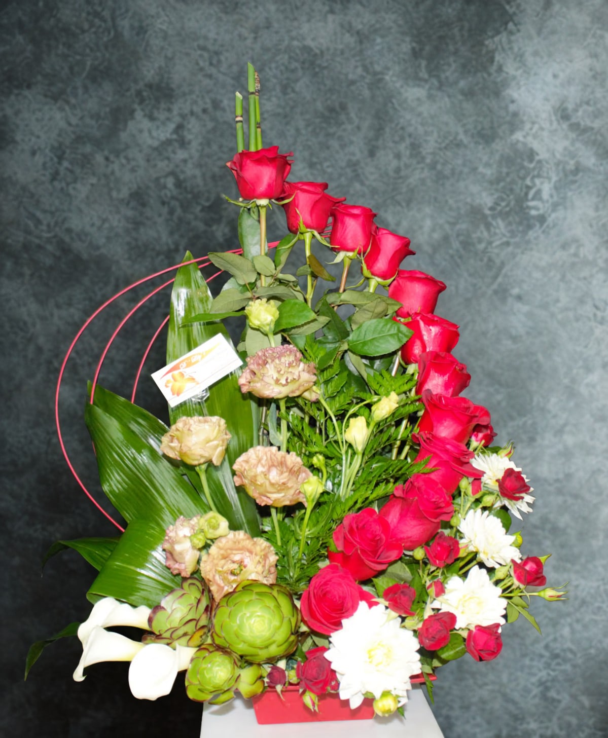Passion Crush  by D'Lily's Flowers  - This creative red rose arrangement is perfect for any occasion! Disclaimer: Flowers may be substituted if needed