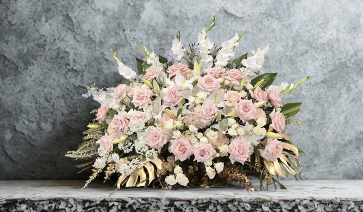 Roses &amp; Radiance - A graceful arrangement of soft blush roses, white lilies, spray roses, hydrendias, and gladiolus, accented with delicate filler blooms and lush greenery. Finished with golden leaves for a touch of elegance. Perfect for expressing love, sympathy, or timeless beauty.