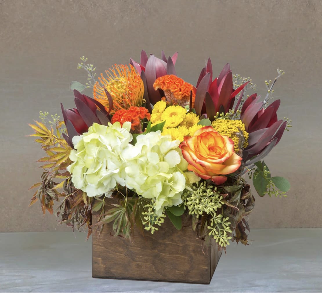 Happiness  - This arrangement likes two things: being inside of a box and delivering happiness in the form of fall flowers. And it’s already inside of a box. Do this arrangement a favor and let it deliver happiness to someone. Order one today! 