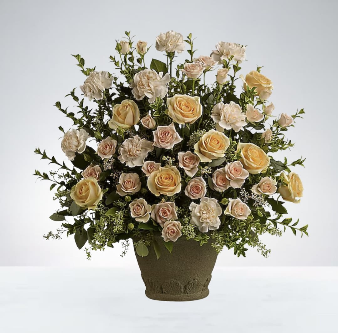Serenity in Bloom - This soft and comforting basket arrangement features peach and yellow roses paired with delicate peach carnations, offering a warm expression of love and remembrance DISCLAIMER: Vase may be replaced if needed to. 
