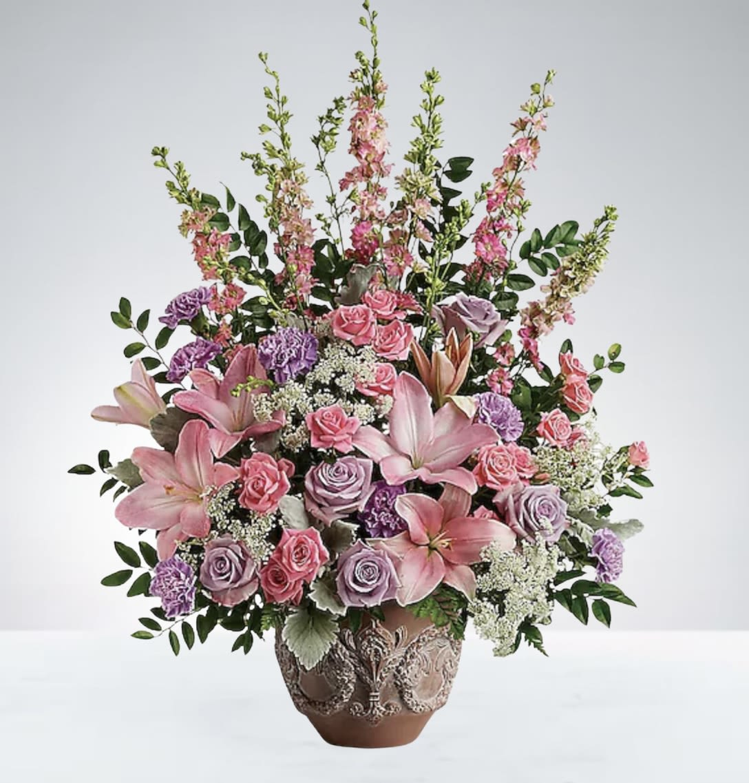 Sweet Serenity - A lovely basket filled with soft pink blooms accented by delicate hints of light purple. This arrangement offers a serene and graceful touch, perfect for adding a subtle pop of color and elegance to any occasion. DISCLAIMER: Vase may be substitute if needed to. 