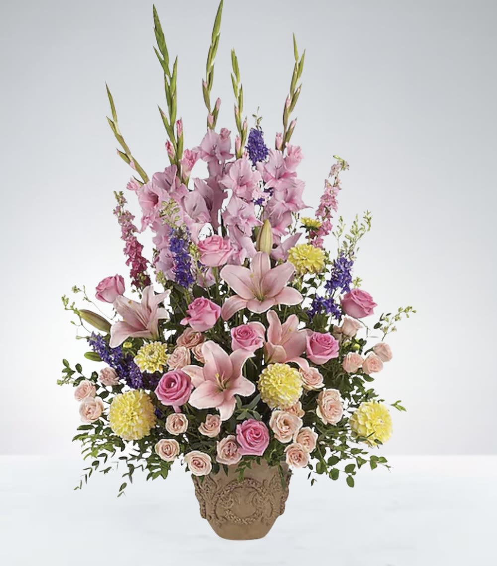 Sweet Meadow Mix Basket  - A beautiful basket filled with soft pink flowers, accented by cheerful yellow and gentle purple blooms. This vibrant yet delicate arrangement brings warmth and joy, perfect for brightening any room or occasion. DISCLAIMER: Vase may be substituted if needed to. 