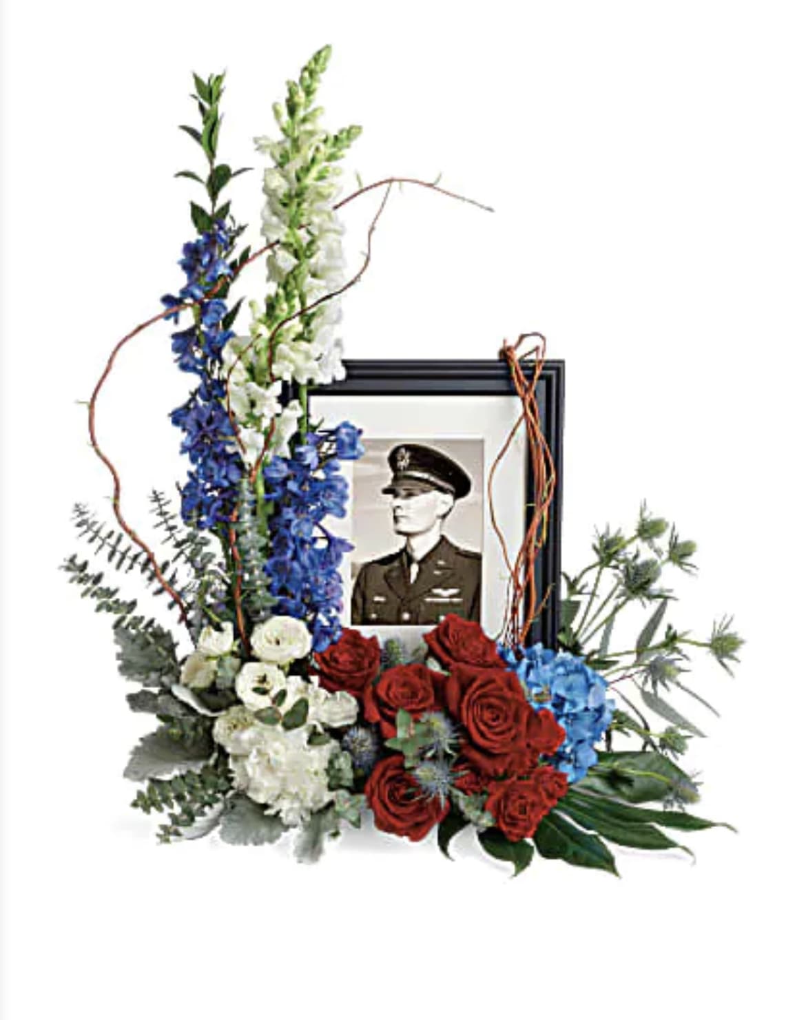 Always With Us  - Honor the memory of an always-beloved with this beautiful display bouquet. Designed to surround a favorite photo, its patriotic mix of blue hydrangea with red and white roses as a respectful tribute.