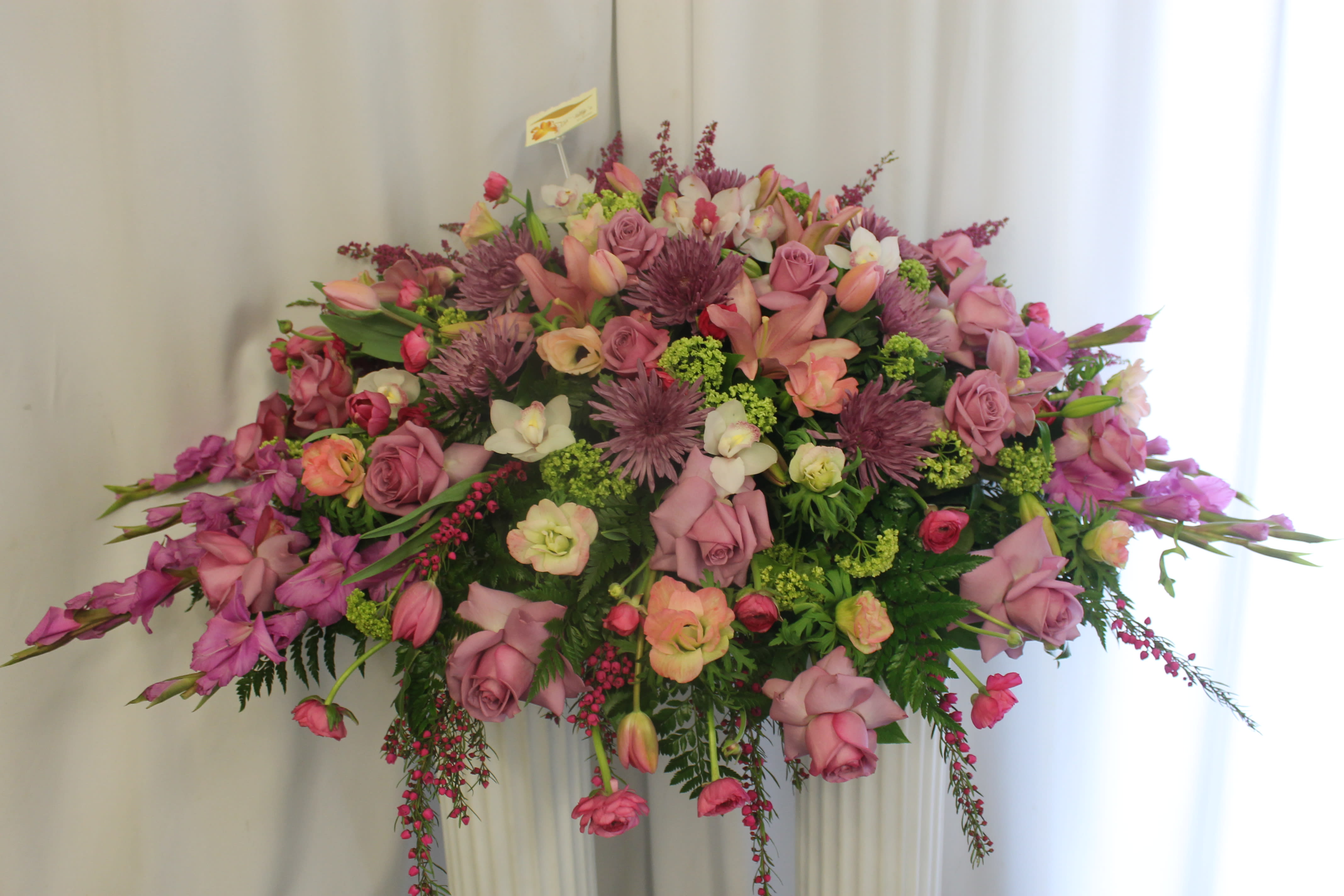 Farewell - Convey your deepest sympathies for their loss with this lovely casket arrangement.