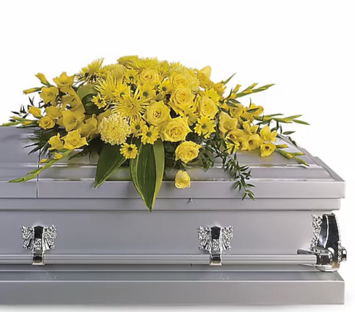 Yellow Grace  - A tender farewell wrapped in warmth and light, Yellow Grace is adorned with a radiant spray of yellow roses, gladiolus, chrysanthemums, daisies, and carnations. These blooms, rich in symbolism, speak of friendship, remembrance, and peaceful rest. This elegant casket offers a serene and heartfelt tribute to a life that shone brightly and touched many with grace and kindness. DISCLAIMER: Flowers may be substituted if needed to. 
