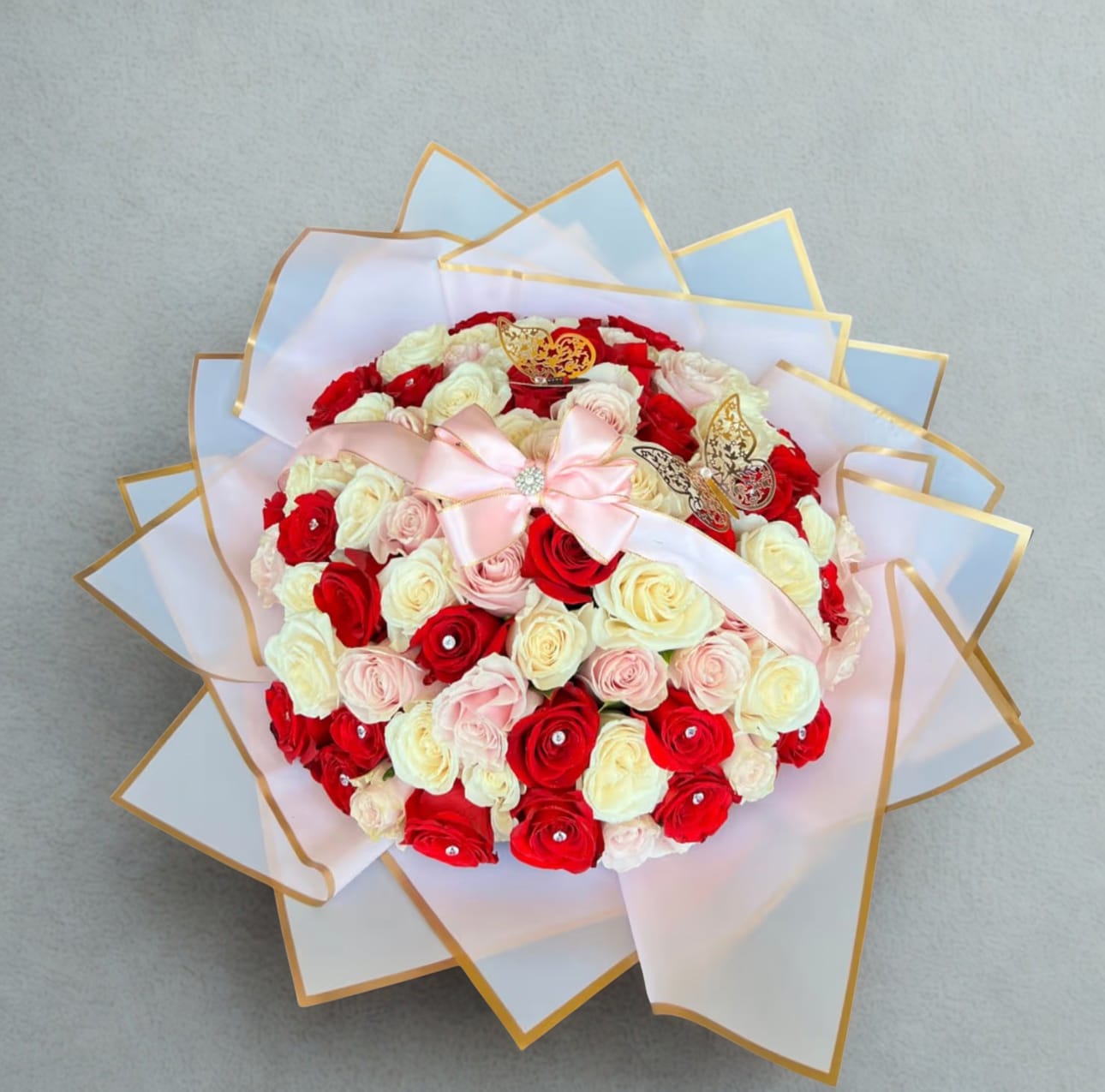 Colorful Way of Love  by D'Lily's Flowers  - This stunning mix bouquet of white, red, and pink roses with a beautiful pink ribbon is a beautiful way to remind someone you love and appreciate them. The picture shown above holds 7 dozens. 