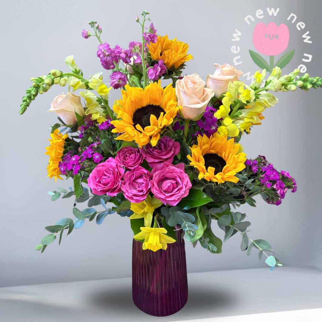 Mrs. Brightside - Celebrate Mom with a design as radiant as she is. Our Mother’s Special features a joyful blend of vibrant blooms, thoughtfully arranged to brighten her day and make her feel truly appreciated. This cheerful bouquet brings together fresh seasonal textures and colors for a look that feels both uplifting and elegant. Recipe: Snapdragons, Sunflowers, Roses, Seasonal Daffodils, Sweet William Seasonal: Daffodils – a symbol of renewal, joy, and new beginnings