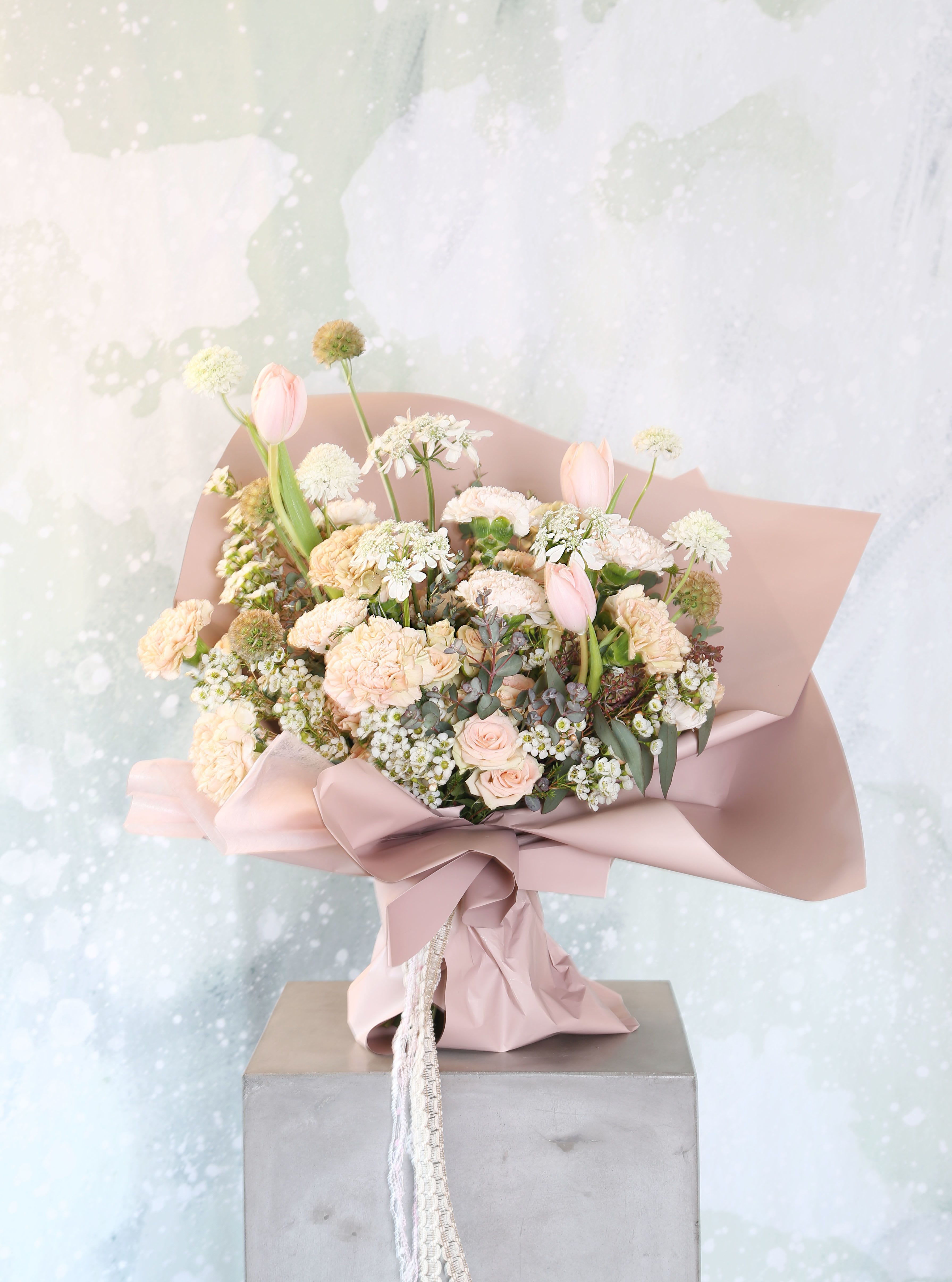 Blush flower Garden handtie - A soft blush, sand color way which express a very gentle lovely feeling to your loved and family. This is an arrangement for whoever you love and appreciate; this arrangement create with blush Ivory Spray Rose , carnation, tulip, Queen Ann lace, scabiosa with seasonal bloom and green which is very delicate and easy for eyes for everyone, this is a Korean paper wrap hand tie carried bouquet. Vase is not included.  But You can order add an a 6" glass cylinder vase, and it will come with branded gift box as pic shown for a more luxury look if deliver with vase. Disclaimer: Photo just represent the overall style, look and feel, which may not be able to identically replicate in some instance. We will only substitute item of equal value or higher value.