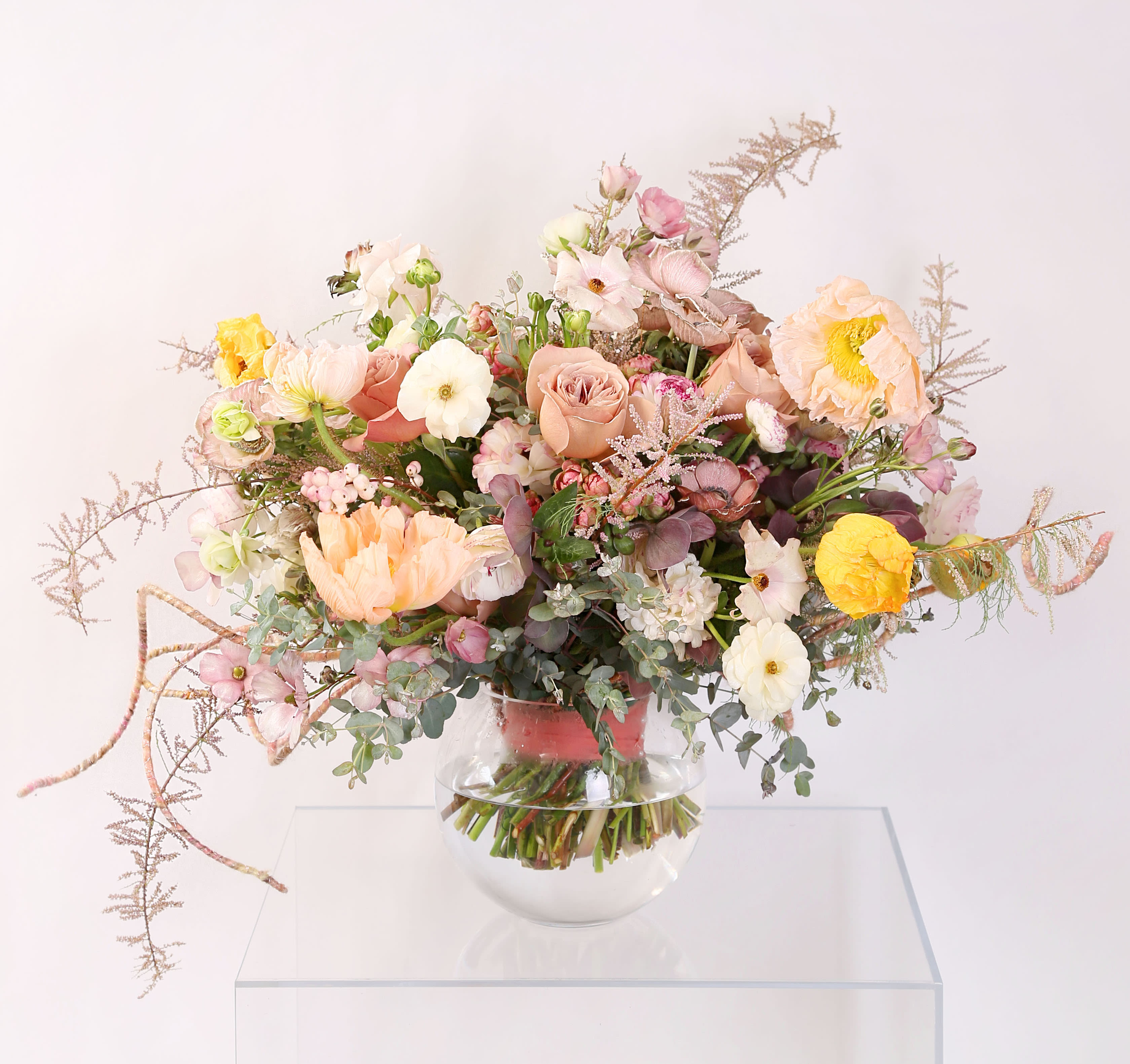 Cafe Latte Rose - A luxury Cafe Latte Garden rose arrangement with butterfly ranunculus, Anemone, poppies, spray rose create a very soft mauve, blush elegant and chic color palette. This arrangement in 8" round vase Disclaimer: Photo just represent the overall style, look and feel, which may not be able to identically replicate in some instance. We will only substitute item of equal value or higher value. 