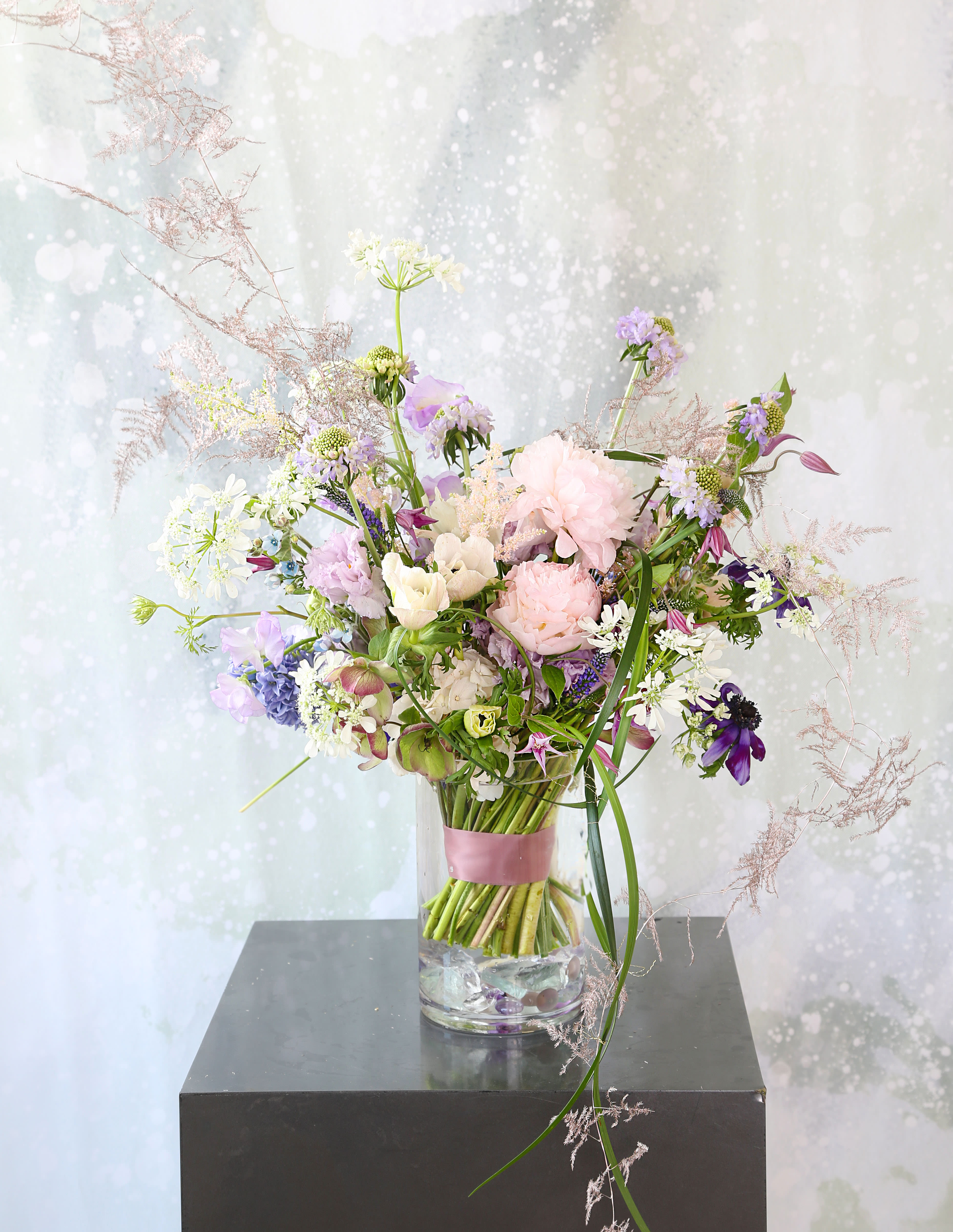 Peony Tendor - A soft Blush Ivory color palette create with Peony, Anemone, and seasonal delicate bloom, decorate with lily glass weaving accent. The elegant fragrant definitely will bring your attention. This handtie bouquet with ribbon wrap in 7" tall vase and packed with our branded gift box. Disclaimer: Photo just represent the overall style, look and feel, which may not be able to identically replicate in some instance. We will only substitute item of equal value or higher value. 