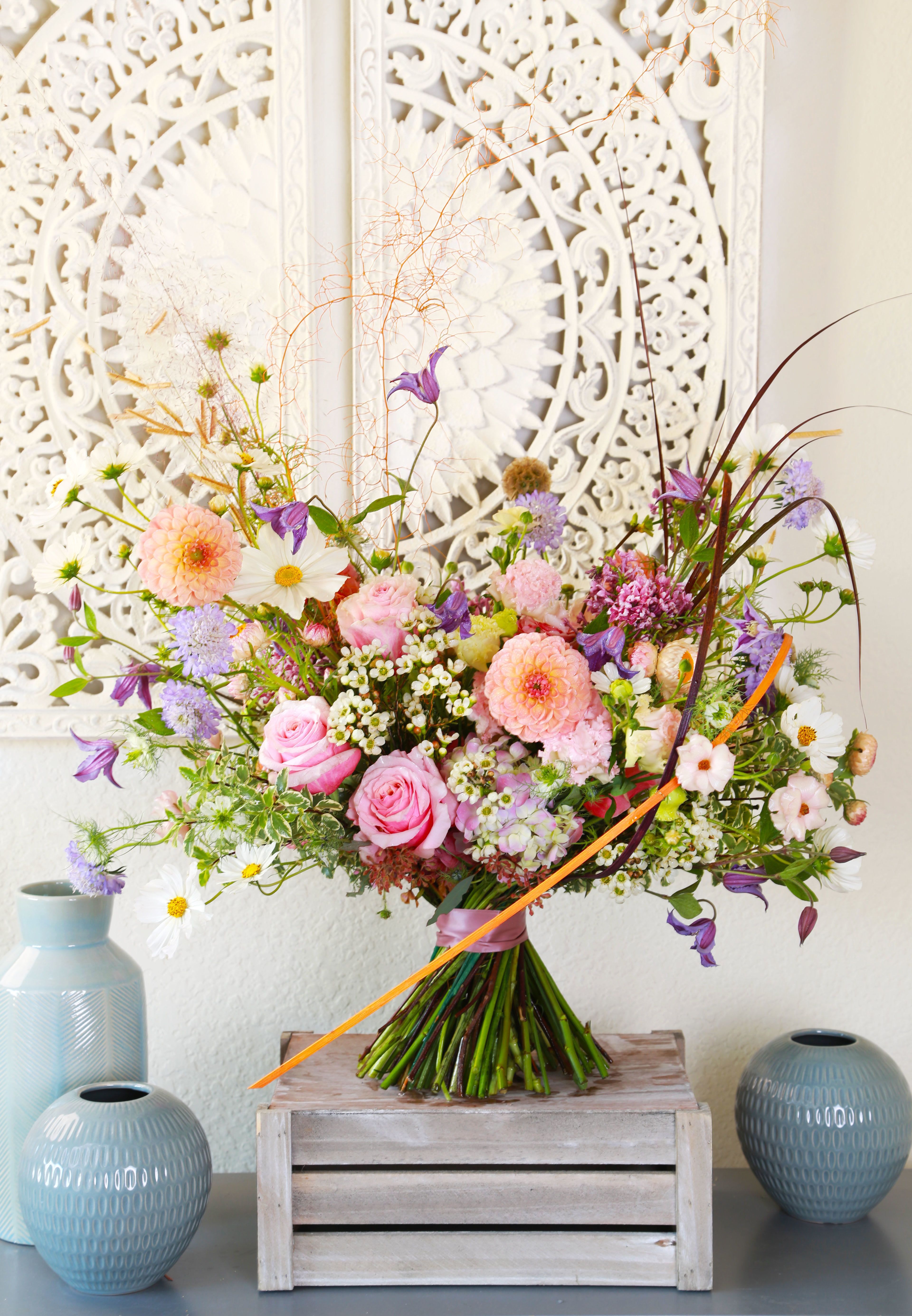 Opulent Blooms - Introducing our "Opulent Blooms" bouquet—a stunning floral arrangement that radiates elegance and luxury. This exquisite bouquet features a lavish selection of rich, velvety roses, vibrant dahlias, and lush hydrangeas, scabiosa, all thoughtfully arranged to create a breathtaking centerpiece that captivates the eye.  Each bloom is carefully sourced for its exceptional quality and beauty, symbolizing love, admiration, and celebration. The deep, rich colors and sumptuous textures blend harmoniously, making this bouquet the perfect choice for special occasions, anniversaries, or as a lavish gift for someone dear.  Displayed in a stylish, modern vase, the "Opulent Blooms" bouquet enriches any setting with its enchanting presence and delightful fragrance. Experience the allure of this luxurious arrangement and make a memorable statement with your heartfelt gift!  We suggest this bouquet arrange in tall vase to feature the artistic and luxe design. This arrangement will deliver will gift box and greeting card.