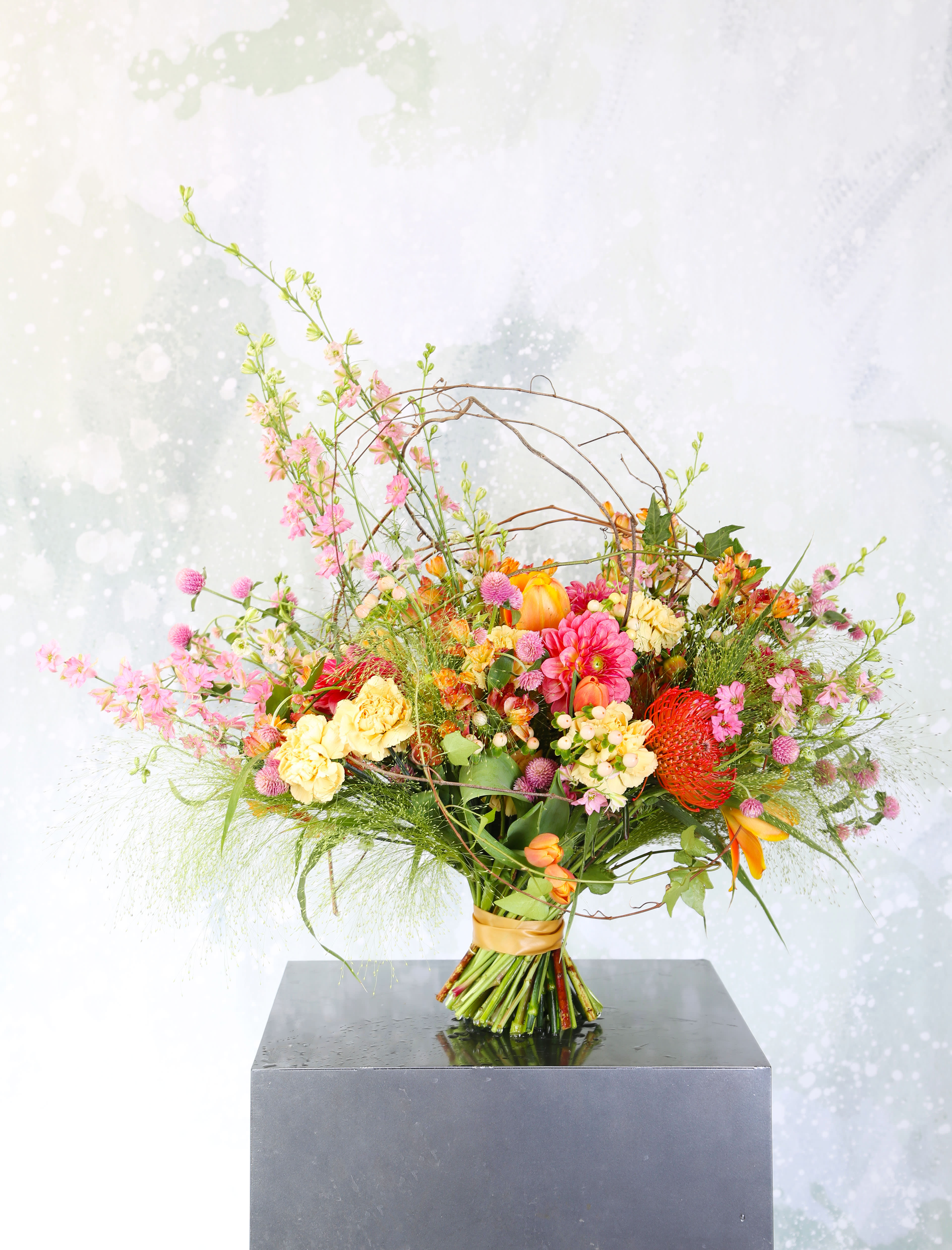 Happy Beauty flower - A colorful bouquet which bring you joy and happiness. This bouquet create with Dahlias, Berry, Carnations, Delphinium, Tulip, Alstroemeria, leucospermum and seasonal bloom. Fuchsia to orange to yellow color way present a modern chic eye catching pieces. This arrangement is hand tie ribbon wrap bouquet. The bouquet can be easily take out to change the water. It delivered with gift box and can be arrange in 8" round ball vase Disclaimer: Photo just represent the overall style, look and feel, which may not be able to identically replicate in some instance. We will only substitute item of equal value or higher value. 