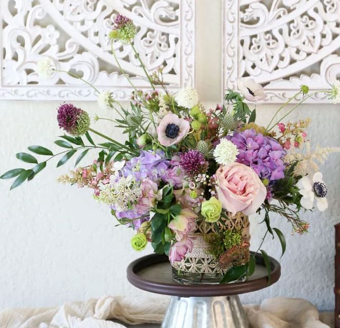 Purple Garden - Different shade of purple, lavender, blush to creme assorted special pick bloom create a refresh elegant arrangement in 5"x5" cylinder Disclaimer: Photo just represent the overall style, look and feel, which may not be able to identically replicate in some instance. We will only substitute item of equal value or higher value. 