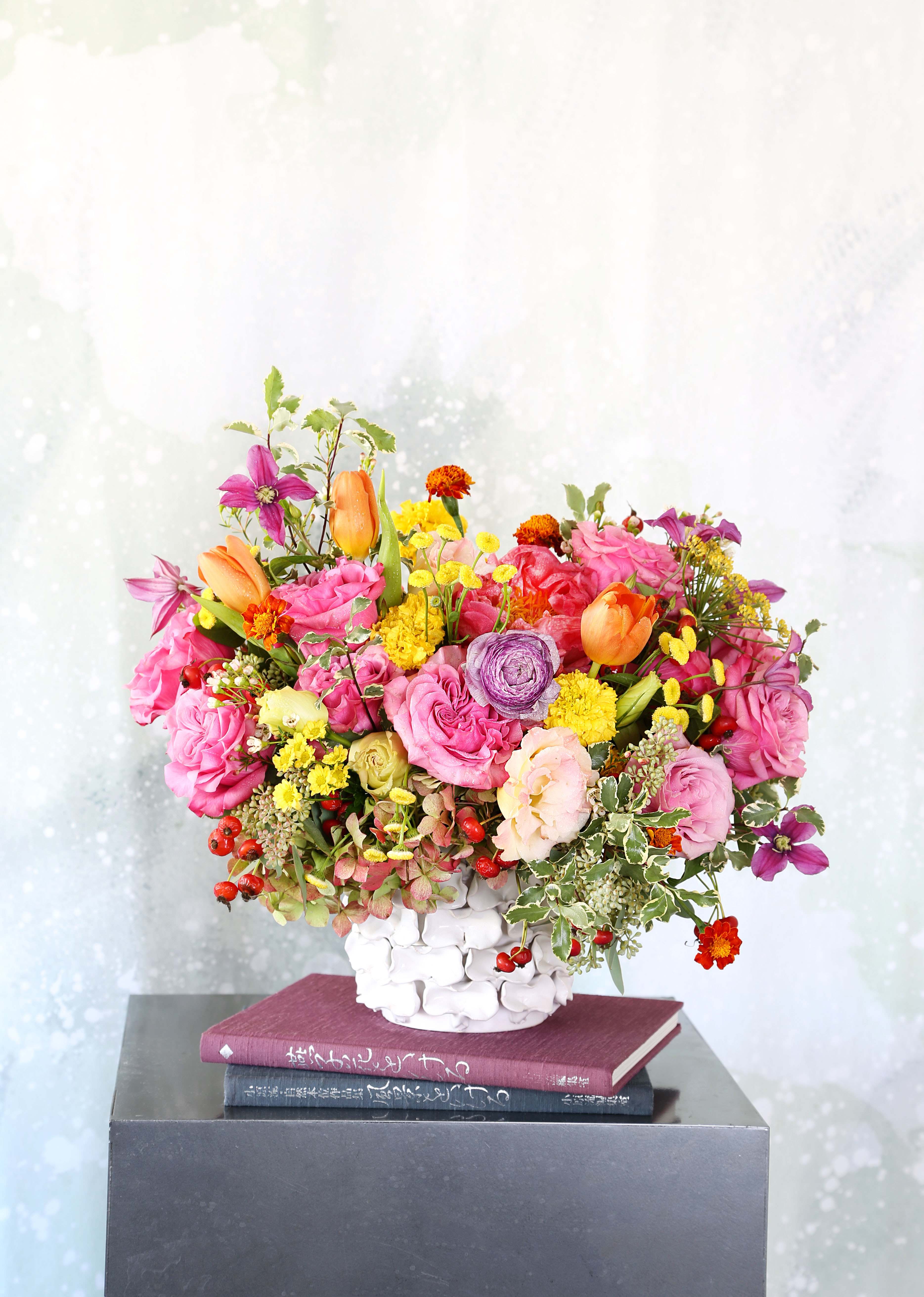 Amore - An unique handcraft texture ceramic vase arrangement with Brilliant color palette create with Garden rose, tulip, Hydrangea, ranunculus, Japanese clematis with seasonal bloom in 8" round vase. This arrangement will deliver wrap with gift box as pic shown