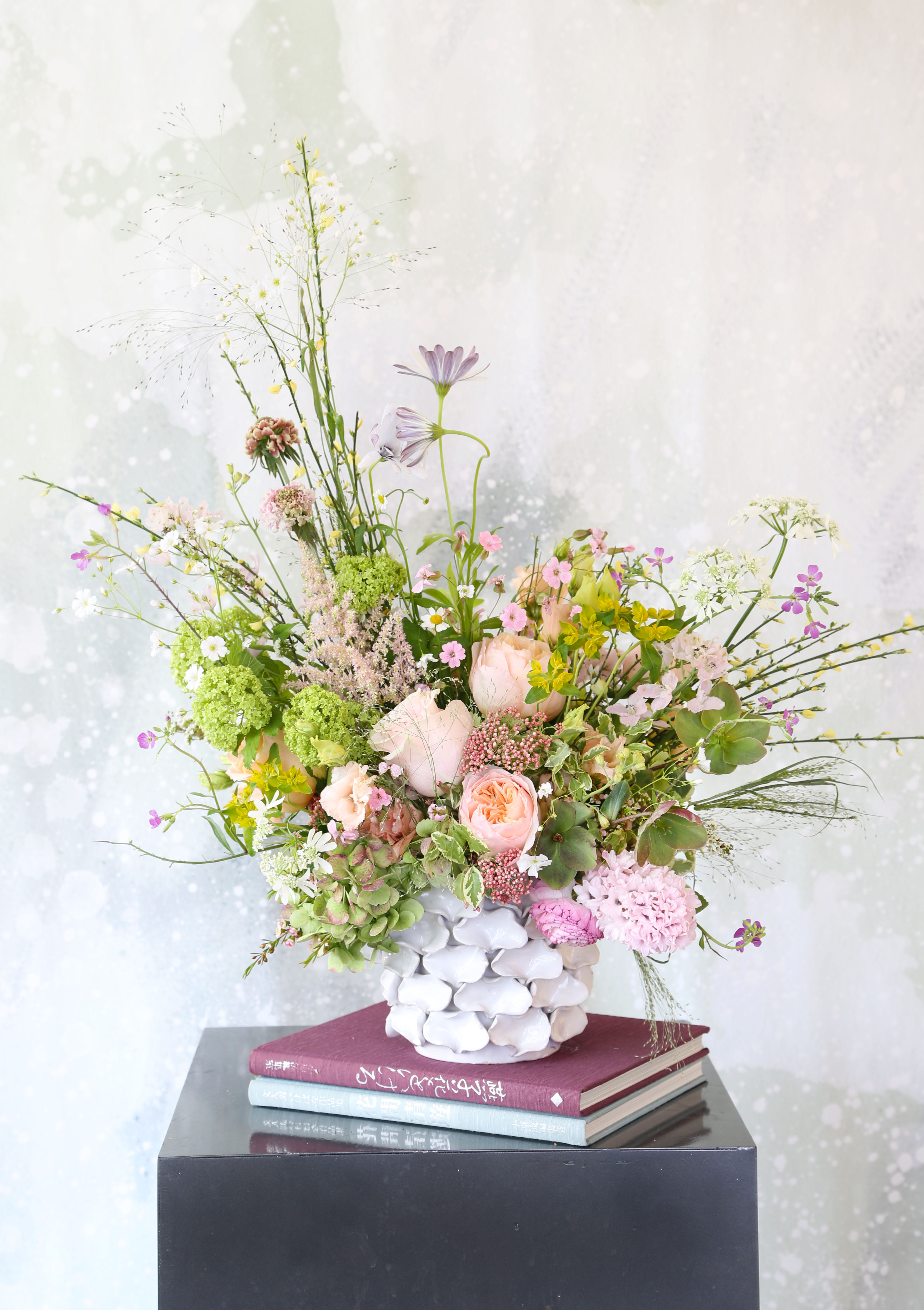 Artful Spring flower garden - This arrangement creates with fragrant garden rose, Hyacinth, hydrangea, hellebore and seasonal bloom, decor with an artful handcraft motif 6" opening ceramic vase. The sweet and delicious fragrant bring in the Spring breeze. This arrangement delivered with branded gift box with greeting cards.