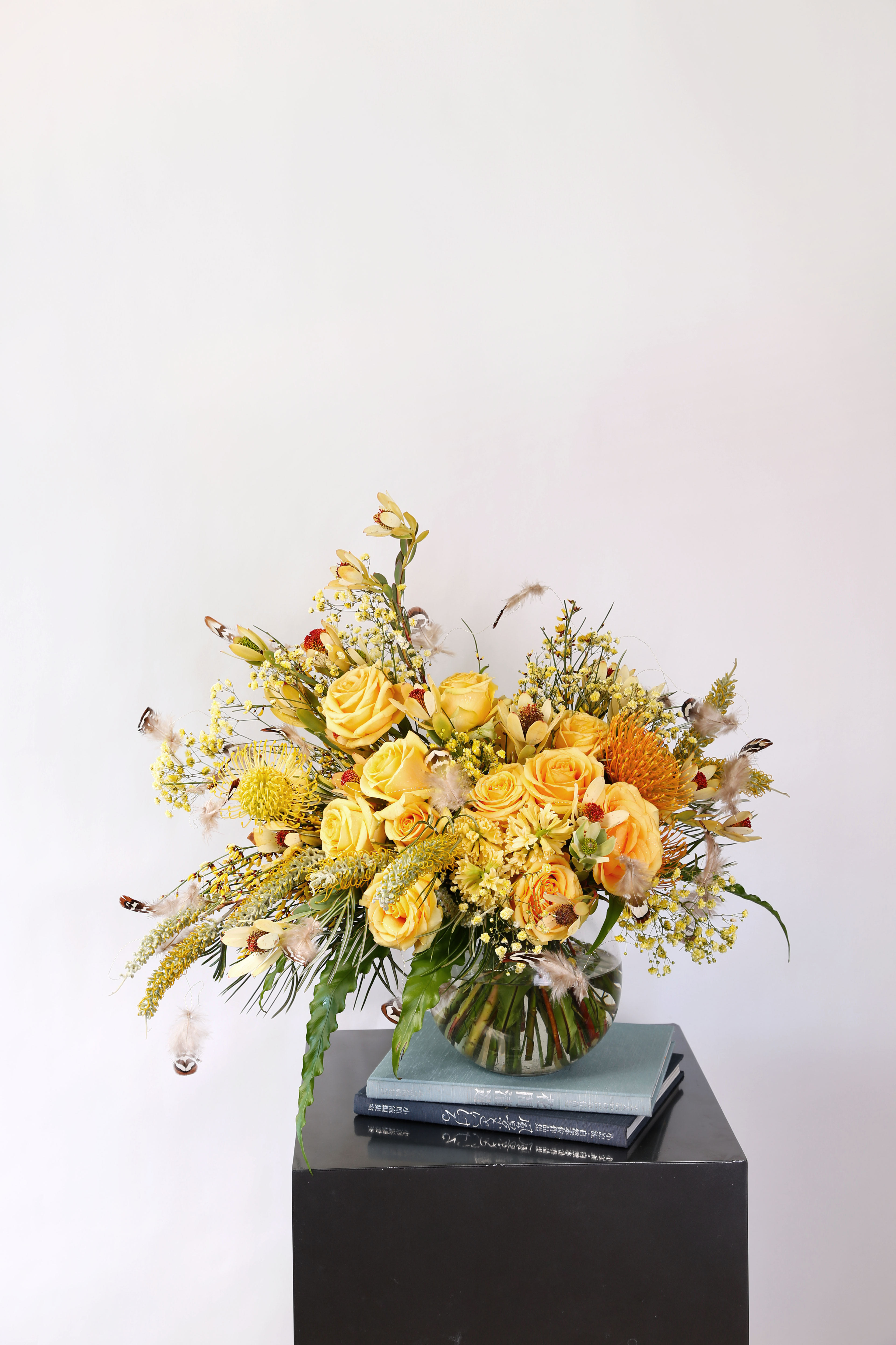 Color of joy - A cheerful yellow golden hand tie bouquet with feather garden brighten up your mind. Arrangement in 8" round vase Disclaimer: Photo just represent the overall style, look and feel, which may not be able to identically replicate in some instance. We will only substitute item of equal value or higher value. 